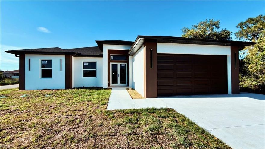 Welcome to this meticulously crafted new construction home with income-producing potential! Offering 2,000 sqft of living space designed for comfort, style, and versatility. This exceptional property features 4 bedrooms and 3 bathrooms, including a private apartment with its own separate entrance — complete with 1 bedroom, living room, kitchen, bathroom, and washer/dryer hookups already in place. Perfect for extended family, guests, or potential rental income opportunities. Situated on a desirable corner lot just off Lee Blvd, this home combines convenience with functionality while still offering plenty of outdoor space and privacy. The spacious 2-car garage provides ample room for vehicles, storage, or your next project. Inside, you’ll find elegant porcelain tile flooring throughout, impact windows and doors for peace of mind, and a thoughtfully designed open layout filled with natural light. The modern kitchen showcases quartz countertops, wood cabinetry, and stainless steel appliances, making it ideal for both daily living and entertaining. The owner’s suite offers a relaxing retreat featuring dual walk-in closets and double sinks in the luxurious primary bathroom. Step outside to enjoy the spacious lanai complete with a summer kitchen — perfect for outdoor gatherings and Florida living year-round. This property truly offers the perfect blend of modern design, flexibility, and prime location.