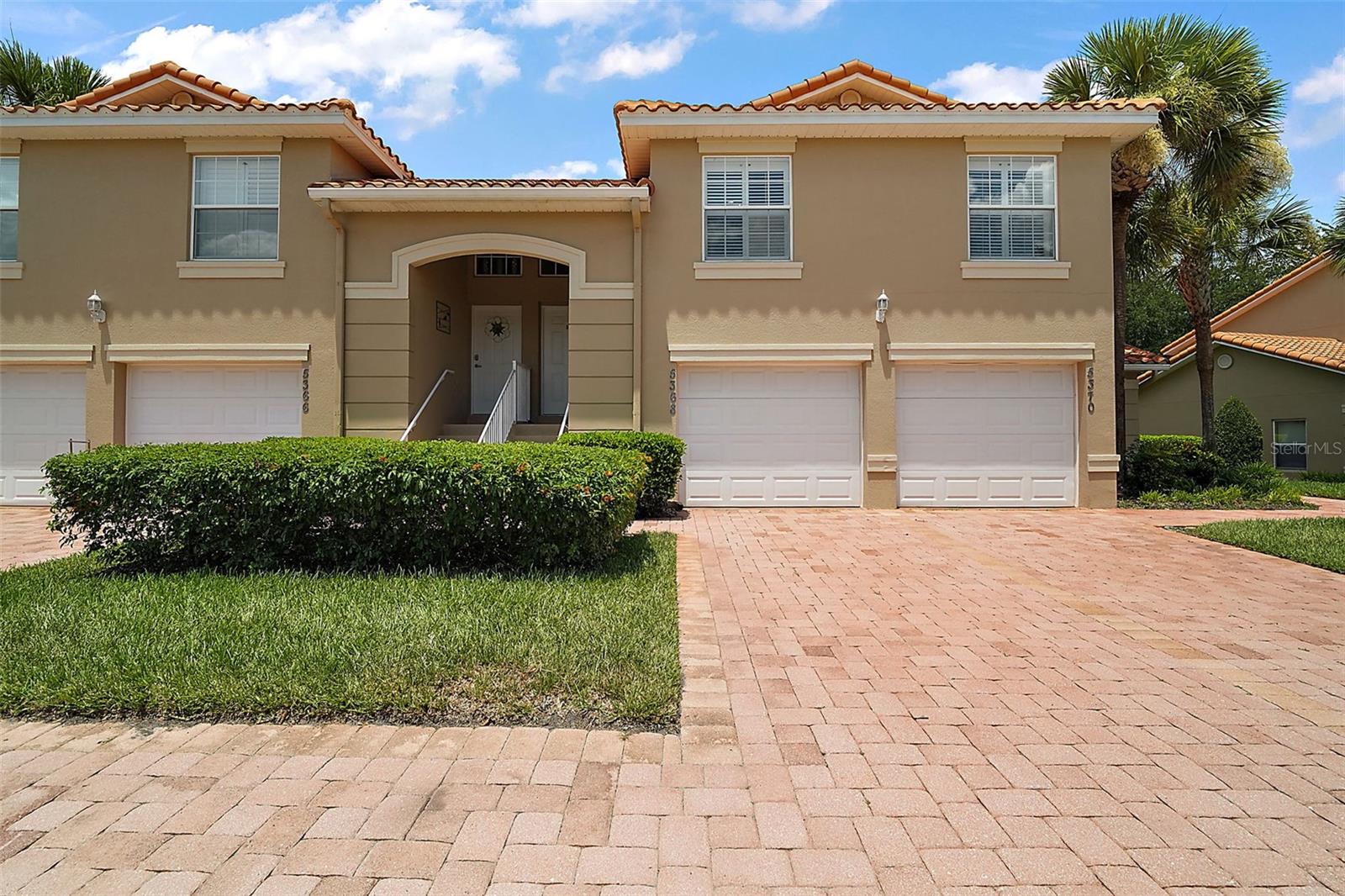Here is your chance to own a fantastic condo in a resort like community. Charming 2/2 condominium in beautiful Lakeside Landings. FORMER MODEL HOME! Interior features include OPEN CONCEPT floor plan, soaring VAULTED ceilings, TILE flooring, PLANTATION shutters, indoor laundry, washer and dryer included! The large, open kitchen boasts CORIAN countertops, abundant cabinets and counter space, built-in desk, eat-in area, and large bar. The kitchen opens to the spacious dining area and living area with sliding doors to the enormous, screened lanai spanning the length of the condo and best of all, NO rear neighbors with a park like view and steps away from one of the community pools . The luxurious master suite boasts a spacious bedroom with soaring ceilings, large walk-in closet, and en suite bathroom with double vanities and a walk-in shower. Bedroom 2 has a double closet and plantation shutters. Bathroom 2 has a tiled shower/tub. Lakeside Landings is a gated, family-friendly community located adjacent to The Villages, only three miles from Lake Sumter Landing Market Square. Lakeside Landings is also conveniently located close to The Villages Charter Schools and Wildwood Elementary, Middle, and High Schools as well as the shopping and restaurants on CR 466. Community amenities include the enormous RESORT-STYLE POOL with multiple fountains and bar area, large in-ground spa and 13,000 sf. clubhouse with INDOOR FITNESS CENTER, ballroom, stage, billiard room, card room, and library. Additional outdoor amenities include second pool and in-ground spa, lighted pickleball courts, lighted tennis court, basketball court, playground, dog park, sandy beach with Lake Miona access, and 140' fishing pier. Looking for MAINTENANCE-FREE LIVING? Quarterly HOA fees include lawn and landscaping maintenance (cutting, edging, fertilization, and pruning), irrigation water and irrigation maintenance for home and common areas, exterior pest control, mulching landscaping beds, and weekly trash pick up. This stunning 2-bedroom 2 bath condo awaits your arrival as it is vacant and ready for a quick close. For your convenience there is a 1 car garage where you can enter into the condo without getting wet during rainy days. Only here you can enjoy a vacation-like lifestyle every day! Don't wait make an appointment for your tour of this fantastic condo and GATED community!
