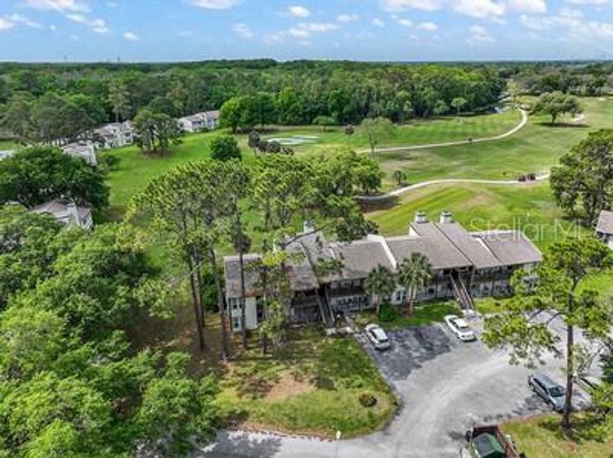 MAINTENANCE-FREE CONDO LIVING... Low-cost living and beautiful golf course views just minutes from The Villages, Brownwood, and Middleton shopping, dining, and schools! This remodeled and updated unit features newer cabinets and granite countertops throughout, along with a spacious great room showcasing vaulted wood beam ceilings and a cozy wood-burning fireplace. A bonus dining/flex space offers the perfect spot for entertaining or relaxing. The updated kitchen includes a brand-new range, dishwasher, side-by-side refrigerator, and washer and dryer that convey. With three spacious bedrooms and three full bathrooms, including private entrances for guest rooms, this home offers comfort and flexibility for family or visitors. Enjoy relaxing outdoors on the wraparound covered front deck, the perfect place to unwind and take in the surroundings. Community amenities include a pool, pickleball courts, and picnic/playground area for you to enjoy! The primary suite features generous triple closet space, creating the perfect private retreat.