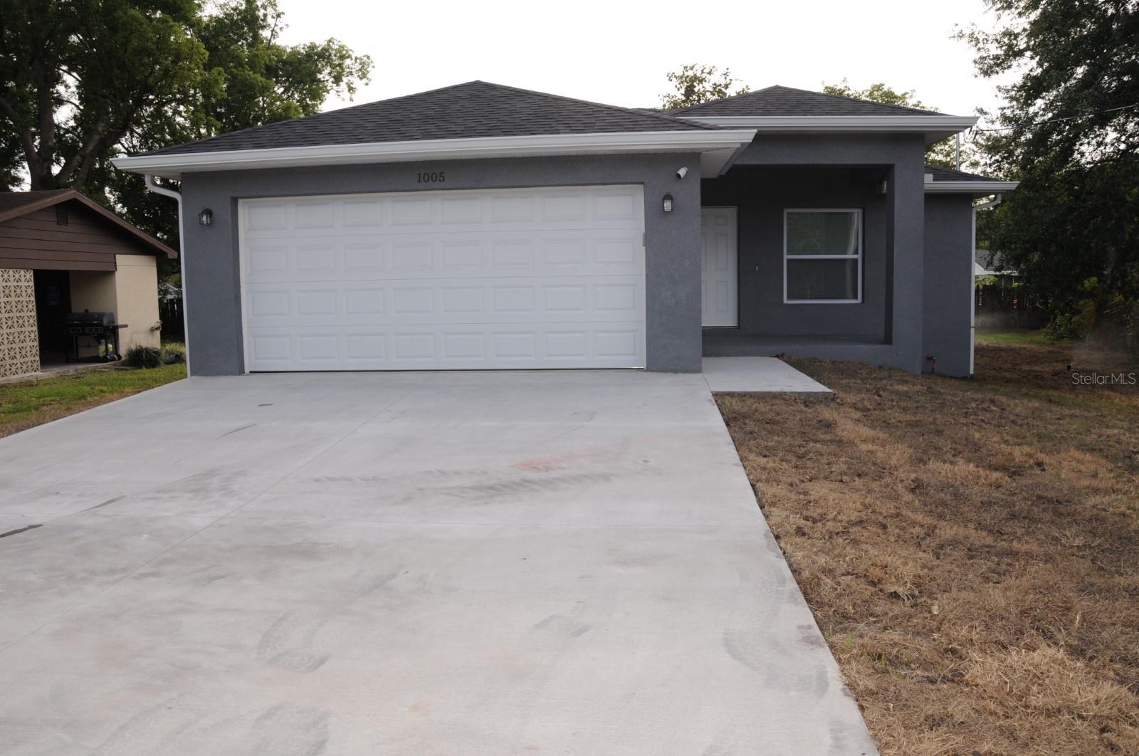 Charming, just completed new construction 3BR, 2BA concrete block home with 1 car garage close to downtown Plant City’s historic district and within walking distance to the Ellis-Methvin Park & the Mike Sansone Community Park. You can be the first family to live in this brand new, beautifully finished home! Everything is new, including a full package of stainless steel and energy efficient appliances with microwave oven! Lots of natural light with oversize windows including designer blinds and features an open floor plan. Kitchen counter tops are solid granite and cabinetry throughout are made of real wood, including a breakfast “peninsula” bar – perfect for casual meals. Bedrooms all have oversize closets including a walk-in closet in the Master BR. Flooring throughout is ceramic and vinyl plank. Bathrooms walls are ceramic tiles and Master Shower is finished with frameless glass door. There is a lovely back porch to sit and enjoy your open backyard that is enclosed with new white vinyl fencing. Washer and dryer hookups are available and ready for your laundry equipment. LAWN MAINTENANCE AND PEST CONTROL IS INCLUDED!! Pet friendly, too!