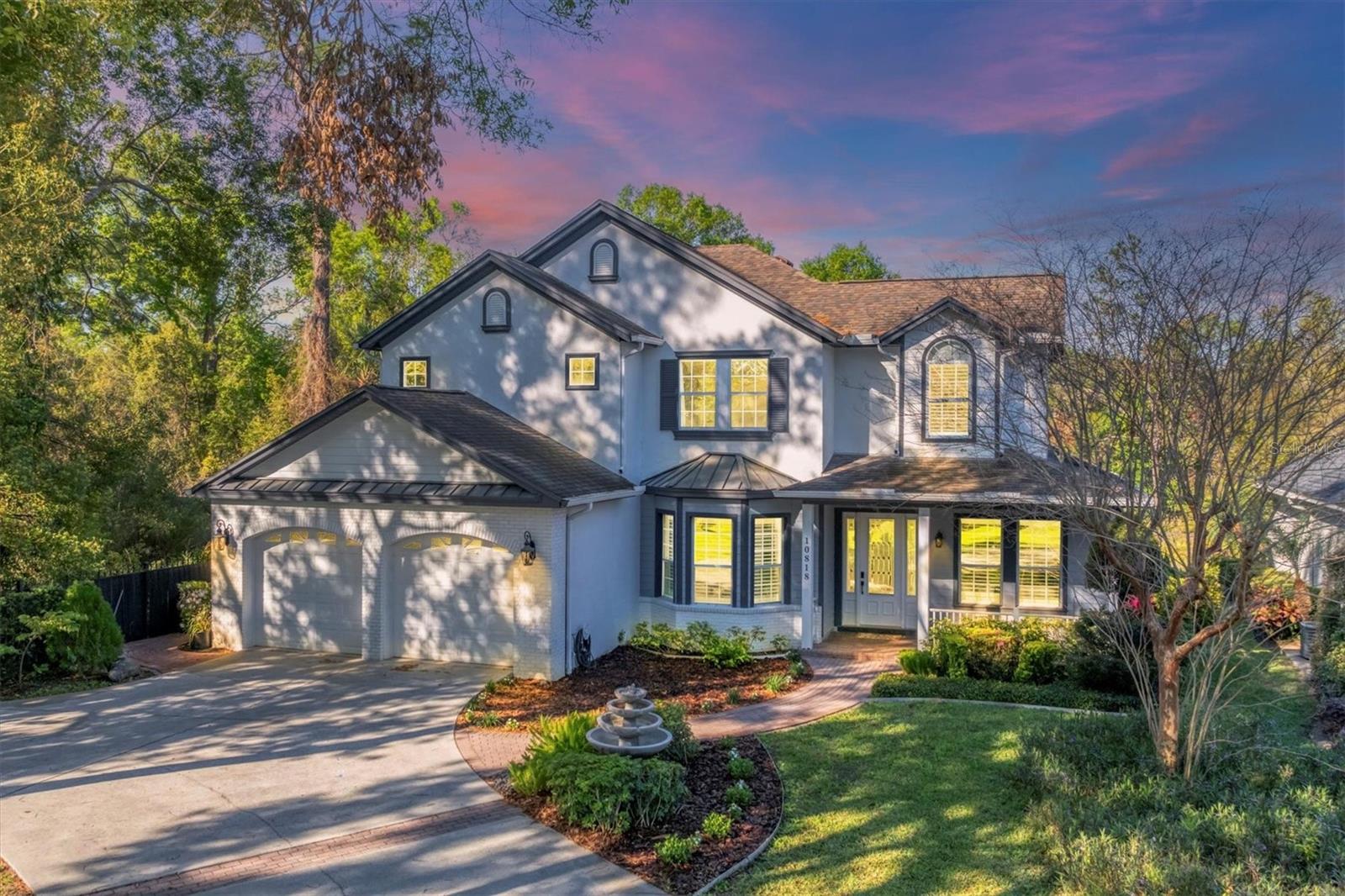 Rare opportunity to own one of only twelve homes in the gated community of Enclave at Carrollwood. This luxurious 3,343-square-foot residence features five bedrooms, four full baths, and a private pool, situated on the largest lot in the cul-de-sac with serene pond views. Recent upgrades include a new pool pump (2023), roof (2016), and dual HVAC systems replaced (2016). The stately façade, long driveway, and charming front porch warmly welcome you home. Step through the custom glass entryway into interiors boasting 10-foot ceilings, crown molding, 6-inch baseboards, plantation shutters, and thoughtfully designed spaces. The formal family room, flex space, or home office is bathed in natural light from its elegant bay window. Adjacent, the formal dining room is graced with a stunning chandelier, chair rail and trim moldings, and a unique butler’s door leading to the gourmet kitchen. A chef’s dream, the kitchen boasts 42-inch custom cabinets with glass display, granite countertops, a central island with a built-in cooktop, stainless steel appliances including double wall ovens and a French door refrigerator, a walk-in pantry, and a breakfast bar. A cozy built-in dinette bench offers stunning views of the pool and water. The two-story living room is a showstopper, featuring built-in shelving and a brick-accented gas fireplace. The expansive downstairs primary suite includes a seating area, walk-in closet, and an ensuite bathroom with double vanity sinks, a soaking tub, a walk-in shower, linen storage, and a private water closet. The main floor guest bathroom with a shower/tub combo is conveniently located for pool days. Upstairs, four generously sized guest rooms—each with a walk-in closet—comfortable accommodations. A hall bathroom with double sinks and a separate tub/shower serves the upper level, while one guest room features a built-in desk and a private ensuite with a seamless glass shower. French doors lead to the outdoor entertainer’s dream: a brick-paved screened patio surrounding the sparkling pool with a stone waterfall, a wet bar ready for your custom touches, a fire pit, and a built-in pizza oven. Relax in your tropical oasis and take in the peaceful pond views. Situated just minutes from Dale Mabry Highway, Carrollwood’s top-rated schools—including Carrollwood Day School—shopping, restaurants, Fresh Market, and convenient access to Veterans Expressway for Tampa Airport, Downtown Tampa, and more, this home delivers the ultimate in luxury living. Homes in the Enclave at Carrollwood—a private gated community of only 12 residences—are rarely available. Don’t miss the opportunity to make this masterpiece your own.