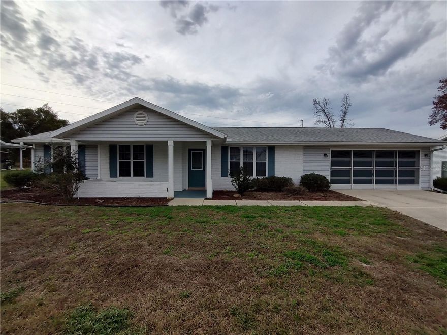 Lovely expanded Hampton model located near the Oak Run Island Club. Home features laminate flooring throughout, living space expanded into back room, leading out to enclosed lanai and covered back patio. Large master suite with walk-in closet and shower with sitting accommodation. Charming kitchen features sitting space, lots of counter space, and tile backsplash throughout. Large two-car garage with work space. A must see!