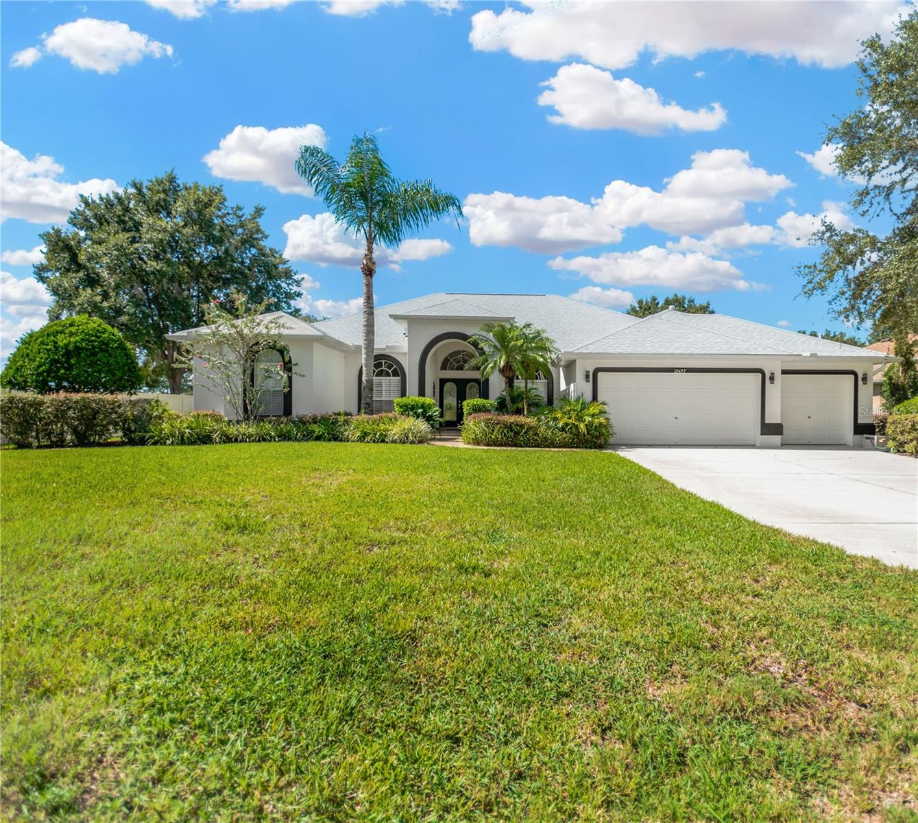 SPACIOUS LIVING, PRIME LOCATION, AND A CHARMING COMMUNITY—THIS PROPERTY HAS IT ALL! Set on over half an acre in the desirable gated community of Creekside with 108 HOMES. This is a well-loved Sunrise built home that offers the perfect blend of space, comfort, and functionality. With only one original owner, this 4-bedroom, 3-bath, plus office, open-concept home is filled with thoughtful features and timeless design. From the moment you arrive, the expansive front yard and backyard offer a sense of privacy and room to roam. Inside, the home boasts volume ceilings and large windows and sliders, flooding the space with natural light and creating an airy, welcoming atmosphere. Step through the stunning double leaded glass front doors into a spacious and open dining and living room area, perfect for welcoming guests. Just to your left, you'll find an office or den, ideal for working from home or creating a quiet retreat.
The kitchen is truly the heart of the home, featuring granite countertops, 42-inch cabinets, stainless steel appliances, breakfast bar, a large double-door pantry, a reverse osmosis system under the sink, and a built-in desk area to keep you organized, ideal for family gatherings and effortless entertaining. The family room is a bright and inviting space, anchored by an entertainment area with built-in shelving that offers both function and style. Above, four large trapezoid-shaped transom windows follow the cathedral ceiling line, drawing the eye upward and flooding the room with natural light. These striking architectural windows not only enhance the sense of space but also add a dramatic touch, making this the perfect gathering spot for relaxing, entertaining, or enjoying movie nights in a beautifully lit setting.
The screened lanai, accessible through three sets of sliding doors, offers a relaxing retreat for enjoying Florida’s beautiful weather.
The oversized primary suite is a true retreat, featuring a large transom window flooding the room with natural light, a spacious en-suite bathroom, a generous walk-in closet, and an additional built-in closet for extra storage. Designed with privacy in mind, the home offers a 3 way split-bedroom layout, placing the three additional bedrooms on the opposite side of the house. Two of these bedrooms are connected by a convenient Jack-and-Jill bathroom, offering dual sinks and a shower/tub combination. The fourth bedroom has next door access to a full bathroom with a step-in shower and a separate exterior door leading to the backyard, making it perfect for guests or backyard entertaining access. Would also make a great pool bath if you decide to add a pool. Additional upgrades include, Roof replaced and Fresh Exterior Paint(2024), Newer kitchen appliances(2023), A/C System(2021), a water treatment and softener system, Surround Sound installed in Family room and back porch, Security system, and custom plantation shutters. Functionality continues with a 3-car garage featuring a workbench and an exterior door leading to the side yard. Best of all—there’s no water or sewer bill, thanks to the private well and septic system. Located within the sought after Newsome High School district, the Creekside community offers added perks like a playground and scenic nature trail. Don't miss your chance to own the land, the space, the schools, and the lifestyle you've been looking for all in one exceptional property. This is more than a home it’s the opportunity you’ve been waiting for.