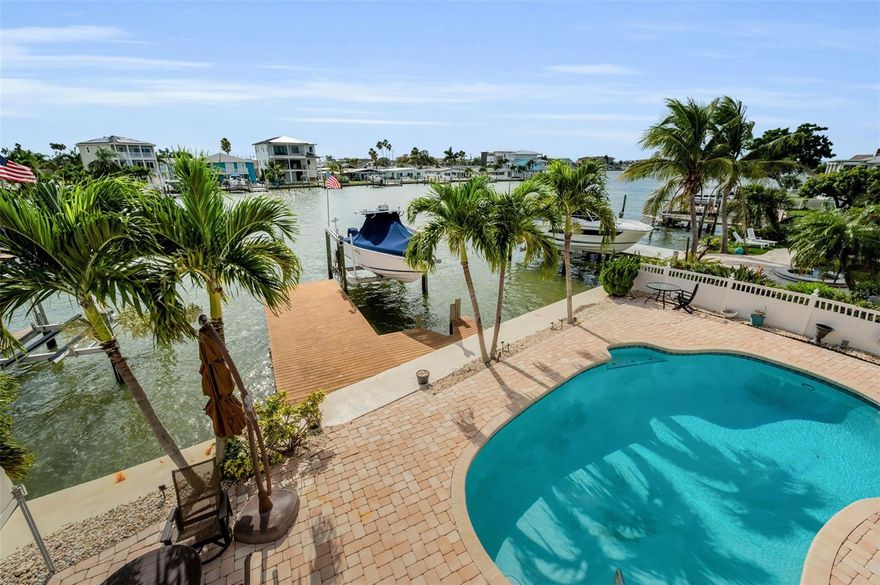 This waterfront pool home in Redington Beach offers a rare opportunity to create your dream coastal retreat or a vacation home with short-term rental potential. With over 3,300 square feet, this spacious 5-bedroom, 4.5-bathroom home is located on 58 feet of deep-water canal frontage and includes a private dock and working boat lift.
Enjoy direct Gulf of America access via John’s Pass in under 20 minutes, making this property ideal for boaters, anglers, and waterfront lifestyle enthusiasts. The backyard features a sparkling pool, expansive brick paver deck, and plenty of space for outdoor entertaining, relaxing, or fishing right from your dock.
The open-concept first floor offers generous living, dining, and kitchen spaces filled with natural light—perfect for entertaining or everyday living. Two first-floor bedrooms, a full bathroom, and an additional half bath in the garage provide flexibility for guests or multi-generational living. The second floor includes three large bedrooms, each with its own private en-suite bathroom, plus covered front and back porches ideal for enjoying sunrise and sunset views.
The first floor was impacted by Hurricane Helene and has been fully remediated, offering a clean slate for renovations and customization. Both air conditioning systems are operational. Additional features include a solar-heated pool, motorized hurricane shutters, and a seawall installed in 2005. The home has been deemed NOT substantially damaged and the county determined structure value for 2024 is $536,764.
Located just minutes from the beach, this home offers free resident-only beach parking, easy access to grocery stores, restaurants, coffee shops, ice cream shops, and local entertainment. Whether you’re searching for a waterfront home in Redington Beach, a boater’s paradise, or a property with income-producing potential, this home delivers location, lifestyle, and value.
Artist renderings of the exterior are available. Schedule your private showing today and explore the possibilities of this exceptional Florida waterfront property.