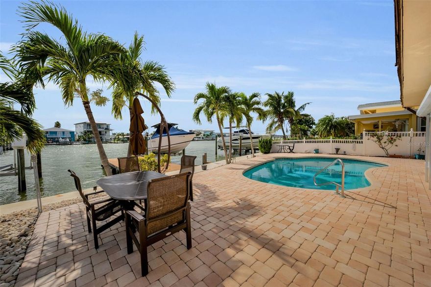 This is more than a home—it’s a lifestyle waiting to be crafted. Reimagine this expansive 3,300+ sq. ft. waterfront home into your dream coastal retreat or a vacation home with short term rental potential! Nestled on 58 feet of deep-water canal frontage, this 5-bedroom, 4.5-bathroom home with a pool, dock, and working boat lift on prime water offers unparalleled potential for luxury living. With direct Gulf of America access via John’s Pass in under 20 minutes, this property is a boater’s paradise and a canvas for your vision.
Step into a light-filled, open-concept first floor, where sweeping living, dining, and kitchen spaces flow seamlessly, perfect for grand entertaining or intimate gatherings. Imagine customizing this expansive area to reflect your style.  There are two spacious first-floor bedrooms and a full bathroom as well as a half bath in the garage.
The second level has three generously sized bedrooms—each with its own private bathroom—awaiting your creative touch. Covered front and back porches invite you to savor morning coffee with sunrise vistas or evening cocktails under starlit skies.
The backyard is a true oasis, ready for immediate enjoyment. Dive into the sparkling pool, lounge on the expansive brick paver deck, or catch fish dinner from your dock, equipped with a boat lift.
Perfectly positioned, this home offers unbeatable convenience: free resident-only beach parking at Redington Beach, and effortless access to local grocery stores, restaurants, coffee shops, ice cream parlors, and vibrant entertainment. The first floor, impacted by Hurricane Helene, has been fully remediated, presenting a blank canvas for your dream finishes. The electric and air conditioning systems are in working order, keeping the home cool and comfortable.
Don’t miss this rare opportunity to create a masterpiece in one of Redington Beach’s most desired locations. Schedule your private tour today and let your imagination run wild!  Other features you will appreciate are: pool heated with solar, motorized hurricane shutters, and a seawall from 2005.  Take a look at the attachments for a beautiful artist rendering of the exterior.  The home has been deemed NOT substantially damaged.