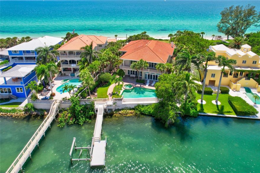 Remarkable Gulf to Bay waterfront estate on the highly exclusive Island enclave of Casey Key, where opulence and serenity unite in perfect harmony. The highly sought-after gulf to bay position allows for the optimal experience in waterfront living. No trade-offs between boating and beaches, this property indulges it all. The bayside overlooks Blackburn Bay, with a dock and lift making the waters easily accessible by boat. The gulf side features a private beach right outside the front door, literally your own slice of the paradise that people converge from across the world to experience.  With walls of glass and an abundance of covered balcony space, this property offers an ideal vantage to capture sunrise over the bay, sunset over the gulf, and the turquoise waters of the Gulf of Mexico all day in between. The expansive, open floor plan is ideally suited for both entertaining and water gazing, with seating areas thoughtfully positioned throughout both floors. Added luxuries include a wet bar, elevator, upstairs laundry room off the owner’s suite, and a dedicated study on the main level. The neutral palette affords the opportunity to easily customize decor and finishes to suit your design preferences. Outside, the resort-like setting is enhanced by an infinity pool and spa, and the grounds feature lush lawns, paver paths, and outdoor dining retreats. Additionally, the property boasts 107 feet of water frontage on the Gulf of Mexico and 80 feet of frontage on Blackburn Bay, providing an extensive and stunning connection to both bodies of water. Savor the tranquility of Gulf to Bay living. Don't miss the opportunity to make this exquisite property your own and experience the epitome of coastal luxury.