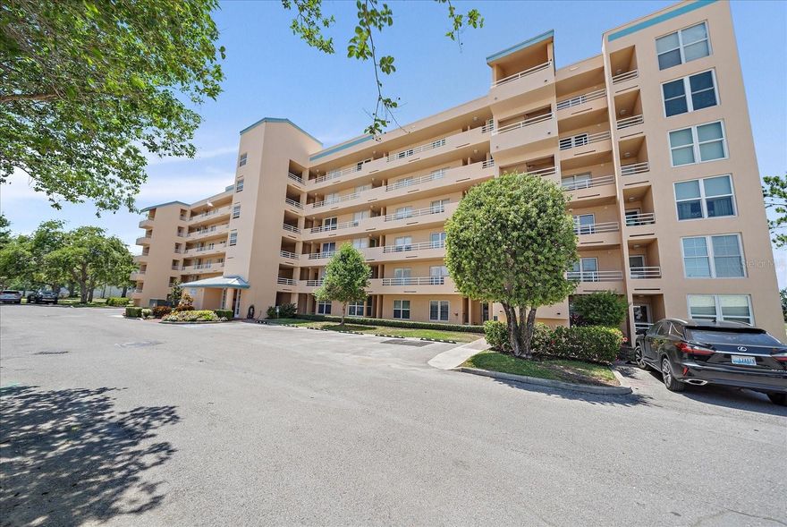 MOTIVATED SELLER! Highly sought after, rarely available, end unit features a 2/2 plus a den and is the largest unit in The Greens at Pinebrook community. The perks of the end units are evident with plenty of natural light from an abundance of extra windows, along with the extra den/flex space with custom built-in TV, storage, and display cabinet which can be used for a 3rd bedroom, office, or TV room. As you enter the unit you will have direct views to the back patio looking out onto the golf course featuring mature trees, ponds, and plenty of wildlife. All of the windows as well as sliders doors have been updated with hurricane impact in 2023 as well as white faux wood blinds and custom solar shades for the lanai sliders. The spacious primary suite boasts large windows over looking the golf course, a huge walk-in closet, and access to the spacious enclosed patio. The split bedroom floorplan has a hallway leading to the second bedroom featuring double closets, the full guest bath, and spacious laundry room. The bright and updated kitchen features quartz countertops, large pass-thru counter, along with soft-close cabinet doors, stainless steel appliances, pantry, and plenty of pullout organizers. This unit features plenty of extra storage along with a separate owner's storage locker. The Pinebrook community features a designated covered parking space for owners, two pools, a clubhouse with plenty of activities, fitness center, game room/library, banquet hall with indoor kitchen, screened poolside patio with grills, and sidewalks lining the streets with plenty of shade giving it a parklike setting. A discounted golf membership is optional but not required. This updated end unit is a must see, make it yours today!