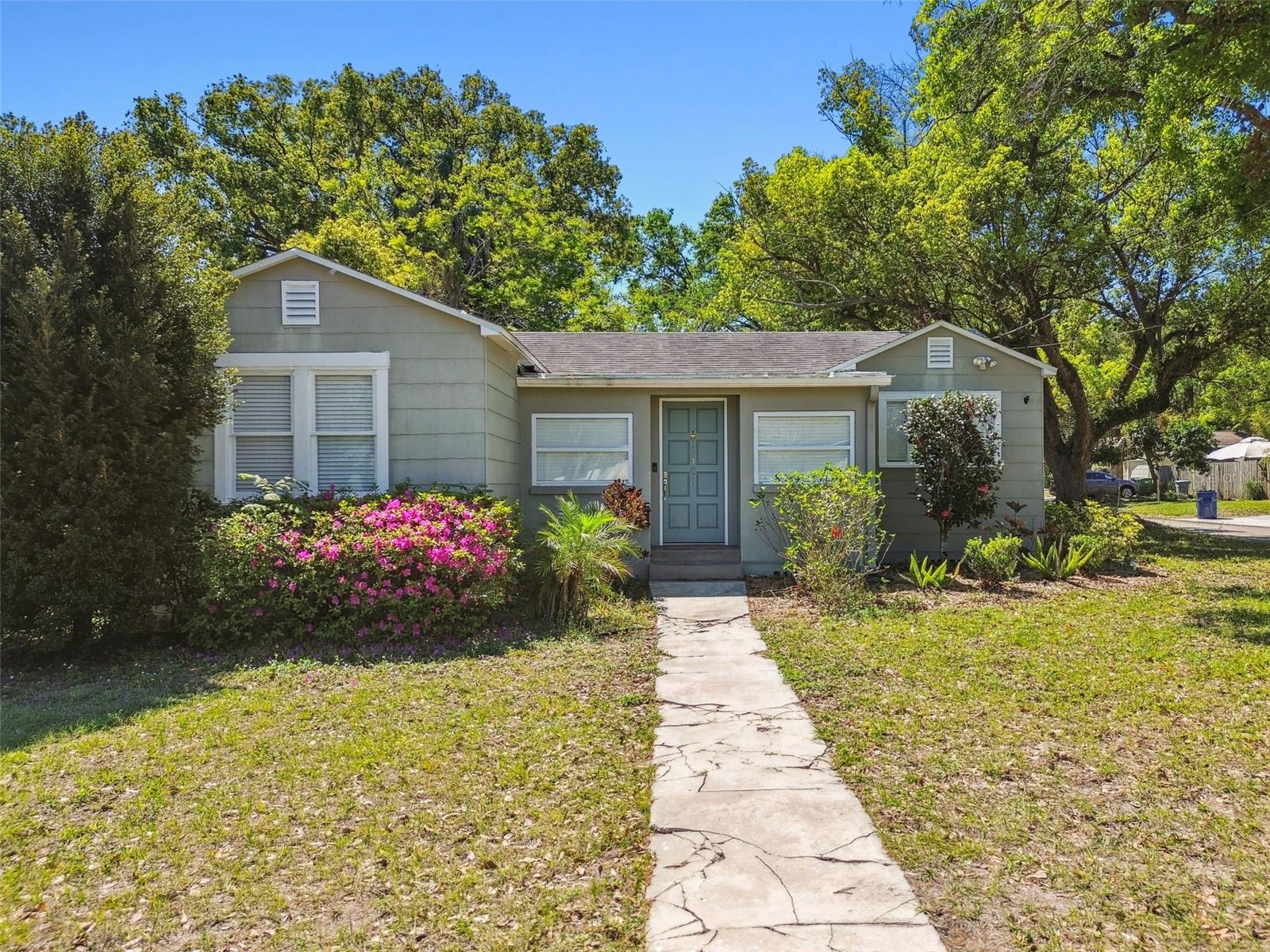 Situated on a spacious 60x140 corner lot in the heart of Seminole Heights, this beautifully remodeled classic revival home offers timeless charm, modern touches, and room to grow. Featuring 2 bedrooms, 1 bathroom, and a versatile bonus space perfect for a home office, reading nook, or sunroom, this home is both functional and inviting. As you enter, French doors open into a bright and airy living room, where natural light fills the space and original hardwood floors add warmth and character. The shaker-style kitchen is thoughtfully designed with stainless steel appliances, soft-close solid wood cabinets, subway tile backsplash, and wooden countertops. Elegant details are found throughout — from recessed lighting with dimmers and classic wainscoting, to the bathroom’s basket weave tile flooring and tiled shower/tub combo. The interior of the home was freshly painted in 2025, with a landscape refresh to match, ensuring it feels clean, polished, and move-in ready. Step outside to enjoy the large fenced yard, ideal for entertaining or relaxing under the covered pergola and expansive deck. A detached garage with automatic door and shelving adds storage convenience. Major system updates include HVAC (2017), Roof (2016), and Water Heater (2013). Walkable to local favorites, McDugald Park, The Corner Club, Hampton Station, Roberta Circle, Magnanimous Brewing, Gangchu Chicken and more! Schedule your private showing today!