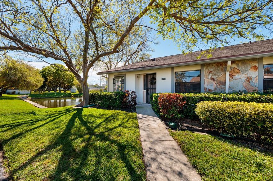 Are you seeking a peaceful environment to savor quiet mornings and evenings? Look no further than this charming end unit villa, flooded with natural light and boasting a picturesque pond view complete with a variety of birds and occasional sea otters. This spacious 2-bedroom, 2-bathroom villa offers privacy with no unit above. Nestled in the southeast corner of the Harshaw Lake Park Condo community, this residence exudes serenity and calm with its tranquil pond vista visible from the screened porch, living room, dining room, and kitchen. Featuring its own laundry room and updated, easy-to-maintain wood laminate floors in select areas, this villa also presents a well-appointed kitchen with pantry storage, modern appliances, and ample cabinetry for culinary endeavors. The expansive living and dining areas are connected through a convenient pass-through. The generous owner's suite accommodates a king-size bed and includes a bathroom with glass shower doors. An additional sizable guest room offers flexibility for visitors or a home office. Storage abounds throughout the villa. Conveniently situated in St. Petersburg, this home affords quick access to downtown attractions, shopping centers, Gulf Coast beaches, and upscale dining options. Seize the opportunity to make this your new haven!