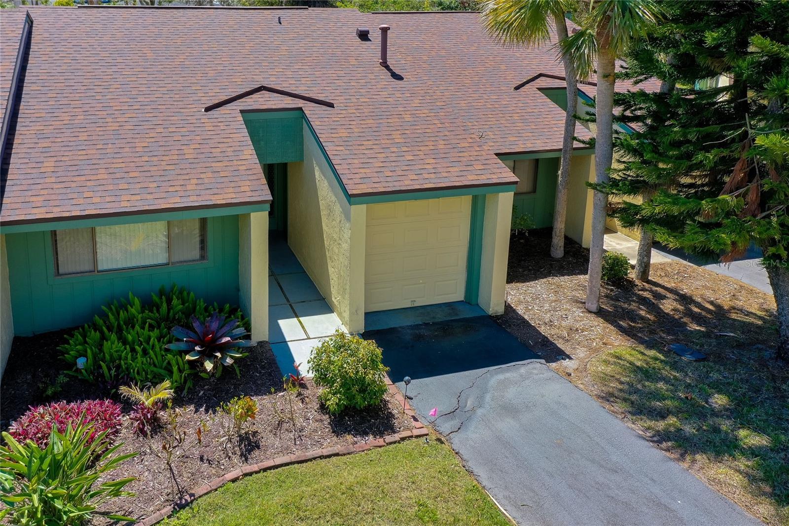 OWNER SAYS SELL. Price adjustment allows a new buyer to enjoy country club living at this renovated 2/2 condo in Sugar Mill. This unit offers a spacious open floor plan with a modern kitchen that flows into the living area. Kitchen has been updated with solid surface stone countertops, sleek cabinetry and high-end appliances, including a gas range/oven. The living room has a high ceiling and newer glass sliders that allow for natural light to highlight the recently painted neutral hued walls. The primary bedroom is spacious and offers an en-suite renovated bathroom. The bathroom flows into the room with a tub/shower combo that also adjoins to the 2nd bathroom. The 2nd bedroom is light and bright with sliders that open to the rear deck allowing a private and natural oasis. Access to the 2nd bedroom from the living room is through newly installed tasteful barn doors. This room could also be used as a sitting room, office or creative space. There is also an attached golf cart garage that offers extra storage for your toys. Walking trails are close, as well as the community heated pool. The gated community offers security and peace of mind. Come see for yourself all that the community of Sugar Mill has to enjoy the Florida lifestyle. Sport packages are available for different levels of sport activity. Sugar Mill is an active community with gorgeous walking trails winding through the subdivisions. It is close to shops and I-95, and is about a 7 mile drive to the beach.