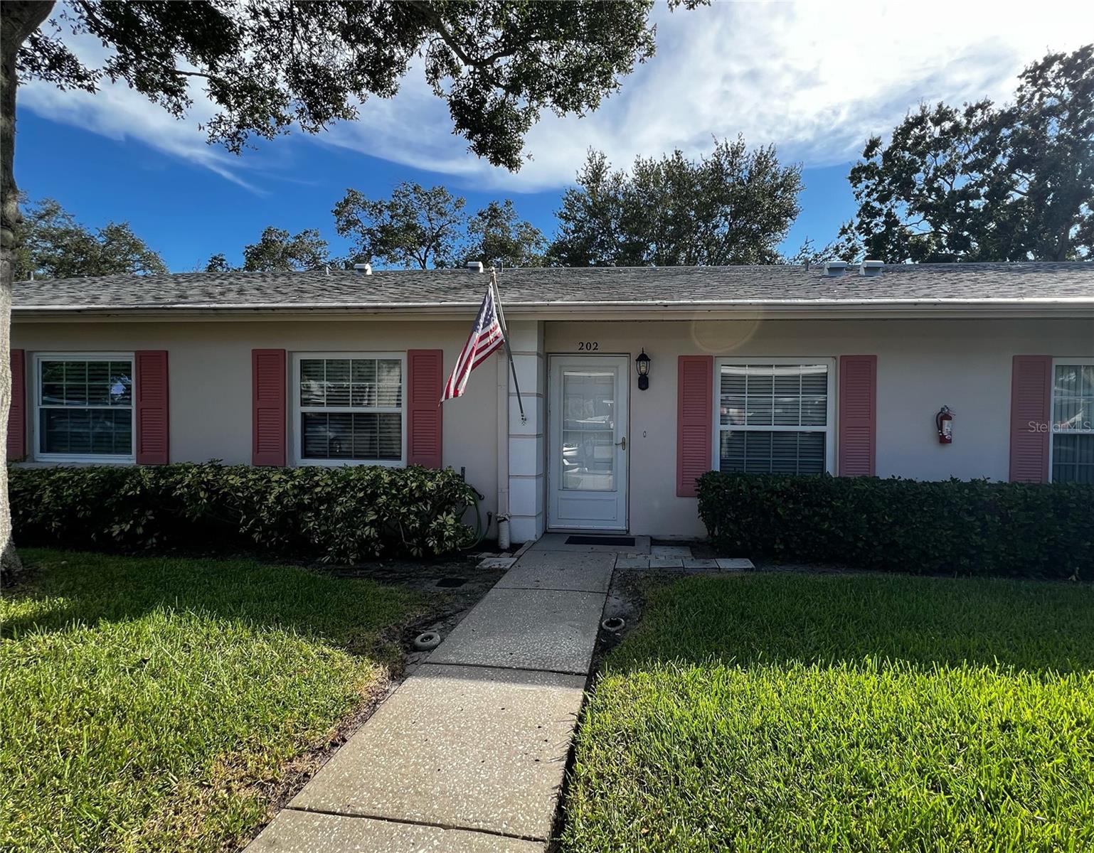 The Move-In-Ready condo you have been searching for has arrived! Welcome to Nelson Place, a highly sought-after 55+ community located in the heart of Clearwater. This complex features just 31 condos in total, and is located within walking distance to a Publix shopping center plus restaurants, a gym, a nail salon, and more. This charming ground-floor villa-style condo offers easy living with no upstairs neighbors! Enjoy peace of mind in this non-flood zone (Zone X) property, too. Inside, you’ll find a thoughtful open floor plan with 2 bedrooms, 2 bathrooms, and plenty of updates, including: brand new AC unit (2024), new water heater (2023), luxury vinyl plank flooring throughout, plus an updated kitchen and stainless steel appliances in the kitchen. The kitchen features a breakfast nook and a bar-top counter perfect for bar stool seating. The vaulted ceilings in the living and dining areas make the space feel light and airy. The sunny Florida room at the rear of the condo brings in plenty of natural light and is a great space to turn into an office, craft room, or peaceful sitting area. Both bedrooms include walk-in closets and a window for natural light. The guest bedroom has a semi-private suite feel, with a hallway that can be closed off and direct access to the guest bathroom. The primary bedroom has its own en-suite bathroom with a walk-in shower, plus a large walk in closet and plenty of bathroom counter top and cabinet space. Enjoy the little things like covered parking just steps from your door, a large indoor laundry closet with storage space, and a paver patio at the back of this condo with hedges for privacy, and a heated community pool and sundeck. Just a short drive to Eagle Lake Park, Clearwater Beach, and both Tampa International and St. Pete-Clearwater Airports, this central Pinellas location puts the best of Tampa Bay — including world-class beaches, golf, shopping, and dining — right at your fingertips. Please note, only one indoor cat or bird is allowed, no dogs.