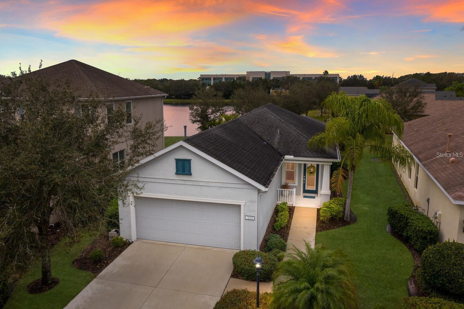 WELCOME to this BEAUTIFULLY UPDATED 2 bedroom, 2 bathroom, 2 car garage POOL home in the highly sought after gated community of Central Park in Lakewood Ranch. This Valor 2 open floor plan by Neal Communities offers comfort, style, and MODERN upgrades throughout. As you enter, you’re greeted by a welcoming living room making it the perfect space to unwind after a long day. The fully updated kitchen features wood cabinetry, sleek QUARTZ countertops, a stylish tiled backsplash, and stainless steel appliances. A dining area just off the kitchen provides an ideal setting for everyday meals. The primary suite includes an ENSUITE bathroom with GRANITE countertops, a single sink vanity, and a walk-in tiled shower. The split bedroom design places the second bedroom on the opposite side of the home, offering privacy for guests or versatility as a home office. Step outside to your PRIVATE screened in pool area, where you can relax and take in breathtaking sunsets over the tranquil pond. Additional features include PLANTATION SHUTTERS, LUXURY VINYL flooring, a NEW A/C unit, and a NEW pool pump (2024). Abundant natural light fills this home, highlighting its thoughtful upgrades and modern touches. Central Park offers outstanding amenities, including a 10-acre park, dog parks, a splash pad, and tennis courts, all with a LOW HOA FEES, perfect for enjoying an active and social lifestyle. Lakewood Ranch is known for their A+ rated school system and is perfectly located just a short ride to downtown Sarasota, St. Pete, world class shopping, fine dining and the FAMOUS Gulf beaches! Don't wait to make this your home and begin your FLORIDA Lifestyle!