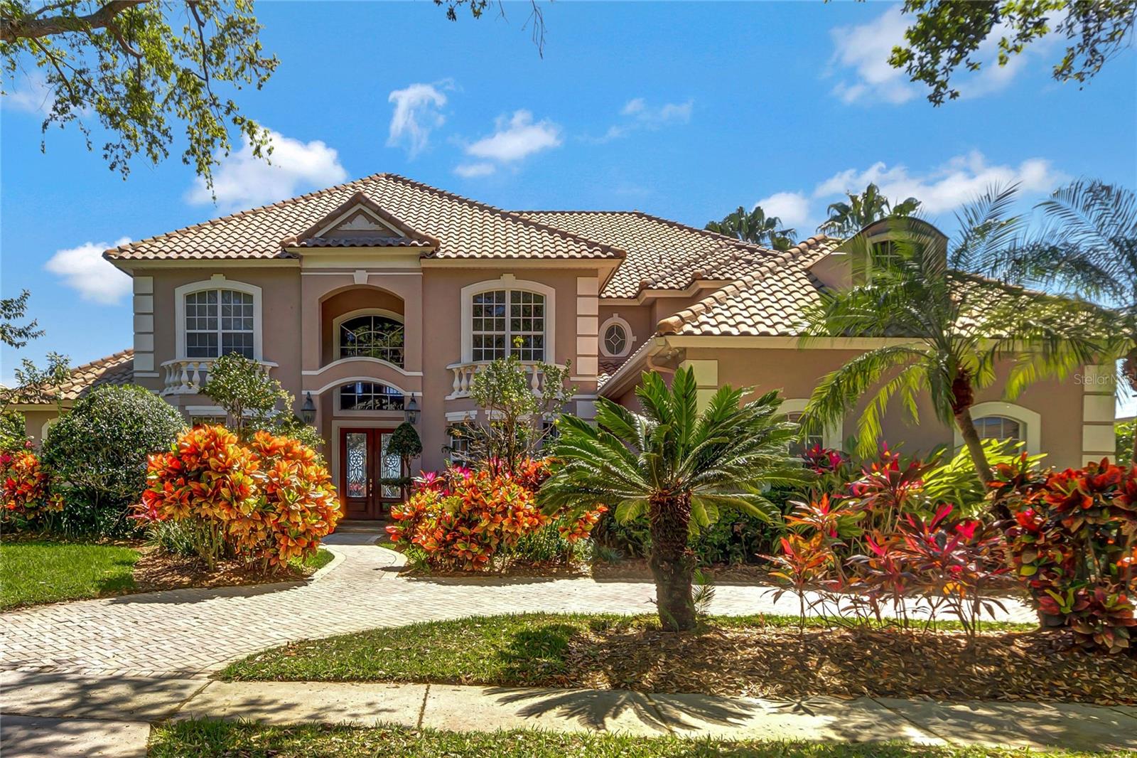 STUNNING LAKEFRONT HOME WITH AMAZING INFINITY EDGE POOL. GRAND ENTRY WITH VIEW OF POOL & LAKE. Must see this 23 ft. Ceiling with decorative design in living and dining area. 5 beautiful Bedrooms plus LARGE ENTERTAINMENT ROOM / THEATER ROOM. WITH WET BAR 30 X16 Master with His & Her Closet plus Jacuzzi and Study downstairs with built in cabinets with private bathroom. 5th Bedroom can be Home Office. EXTRA LARGE FAMILY ROOM WITH SPECTACULAR LAKE VIEWS + GAME ROOM. Double crown molding, columns, and open floor plan. Wide upstairs hallway. Fantastic view with bedrooms either side, and lots of space. Open Kitchen with Granite Island, extra-large Pantry, and all stainless-steel appliances included. Master + Study Down, 4 Bedroom + Bonus Room Upstairs. 3 A/C’s newly replaced. LARGE LOT with Mature trees and lush landscaping. Exterior Painting done in 2022 LARGE POOL & SPA, HUGE PORCH INCLUDES BUILT IN SUMMER KITCHEN WITH SINK. 3 Car Side Entry Garage, Circular Drive, Termite Bond, 24 hour gated and guarded community, 3 playground areas, Tennis Court, Basketball Court, and Community Boat Dock. Close to hospitals, schools, doctors’ offices, 80+ restaurants, Trader Joes & Whole Foods. 25 minutes to the International Airport, & Disney World. 5-10 minutes to malls, many grocery stores & fitness centers. Best of everything in Dr. Phillips area. Enjoy Phillips Landing! (Sq. Ft. per Builder Plan) CANNOT FIND A BIG HOME AT THIS PRICE IN A 24 HOUR GUARDED AND GATED COMMUNITY IN DR. PHILLIPS. HURRY AND SEE THIS BEAUTY.