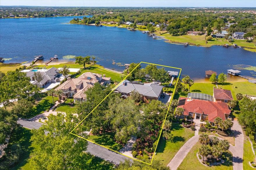 Gorgeous Private Lakefront Custom Brick Estate over 10,000 sq ft under roof, just under 7,000 sq ft under HVAC.  First Time Ever on Market! Step thru the Gorgeous Leaded Glass Doors into this Magnificent Estate the Entry made for Royalty Custom Magnolia Curved Staircase with custom Italian Marble Flooring installed 2024. Updated Massive Chandler with Sconces lighting grace the Staircase. To the left the formal living room to the right Formal Dining Room with a New Modern Chandlier both rooms have Custom Built Out Windows that engulf the Rooms with Beautiful Light. Step into the Extraordinary Library/Office see the Custom Workmanship Lighted Display/ Bookcases, The Mantel and the Stunning Fireplace a True Masterpiece of Art. From Enry or Library step into Massive Family Room A Entertainers Dream Home lined with French Doors with Incredible Views of 136 Feet of Lakefront Views from every Angle or step thru the doors to 1,600 sq ft screen in Patio with Outdoor Kitchen and Service Bar again Lake Views from every angle.  A Hidden Suite with another enclosed Balcony. Step in from the outdoor kitchen into the Large Dinette and Large Custom Kitchen has window to service bar on patio!! Yes with all new GE Cafe Stainless Appliances . A Custom Butler Pantry leads to Formal Dining Room. With a Large Food Pantry in Kitchen as well.  Go up the back Stairs go to the right A Massive Gameroom with Custom Wet Bar and Upper Deck for Lounging of course that leads to Upstairs Enclosed Balcony! Yes a Entertainers Dream!! The Gameroom Bath is shared with bedroom #6.  Pass 3 more bedrooms to the over 1,000 sq ft Master Suite with a Bathroom fit for King or Queen Yeas with its on Enclosed Balcony.  Also there is a 400 sq ft open balcony for private sunbathing.  This Estate boast of a Resort Style Pool and Spa pathways to Gazebo and Trellis on to deck leading to Large both house with lift for large boat and 2 Ski Dos. Oh of course the oversized 4 car side entrance garage freshly tiled 2025with lots of Closet Storage.  Now there is two tall Privacy Hedges on both sides of the Home.  New $125,000 roofs House, Gazebo and Boat House installed 2024, 3 New Permitted A/C s just install 2025. Home was replumbed.  All new modern electrical switches and receptacles installed 2025.  The dock was built to house a large ski boat the with 8 x 8 piers.