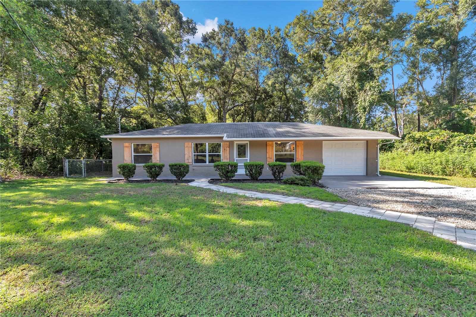 OWNER/SELLER FINANCING!! Welcome to this stunning 3 Bedroom, 2 Bathroom home that’s been fully transformed from top to bottom and is truly MOVE-IN ready. As you step inside and you’ll immediately notice the thoughtful updates, fresh interior and exterior paint, NO CARPET in sight, and clean modern finishes throughout. The split floor plan offers three comfortable bedrooms, giving everyone their own space. A spacious mudroom and oversized indoor laundry room add convenience to everyday living. The garage has been refreshed with a sleek, painted floor that feels polished and functional. This home also features a brand-new water heater, giving you peace of mind for years to come. Outside, the large backyard is made for entertaining, complete with a brand-new deck, patio, and firepit—perfect for gatherings under the Florida sky. Ideally located near Highway 484 and 75, and you’re just minutes from The Villages and grocery stores, yet tucked into a quiet setting that feels away from it all. This home is EASY to show, request your private tour today!