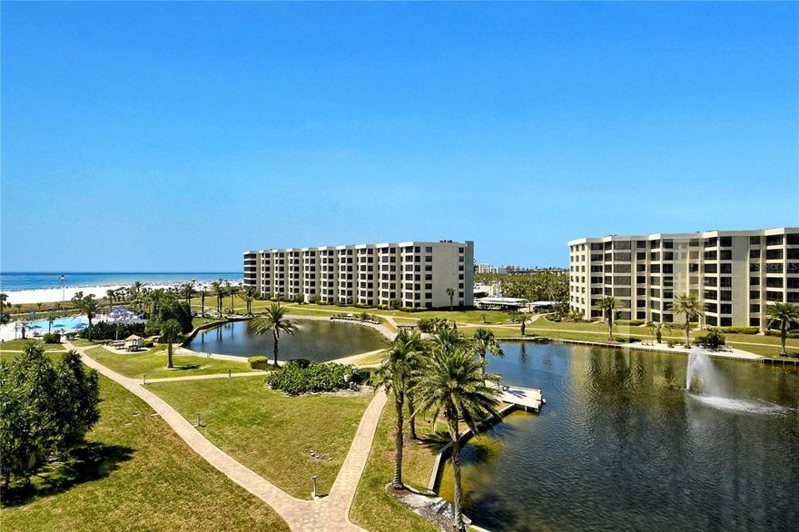 Your dream home awaits — this rarely available, turnkey furnished, 3 bedrooms, with 2 ½ baths, offers 1919 sq ft of luxurious living space. This stunning end unit at the prestigious Gulf & Bay Club boasts expansive windows filling the condo with natural light and providing breathtaking views of the freshwater lakes and fountains. The open kitchen is the heart of the condo featuring Corian countertops, Kitchen Aid appliances, and a walk-in pantry. Both full bathrooms offer dual sinks, and both walk-in closets have built-in organizers offering ample storage. Enjoy serene evenings on the enclosed lanai and year-round comfort with the brand-new AC. Located within the exclusive 24-hour guard gated community of Gulf & Bay Club on Siesta Key, this condo offers access to top-notch amenities spread across 32 acres. Relax on a beach chair on your 800 ft of private white quartz sandy beach — named #1 in the country and #4 in the world! Featuring 3 swimming pools, 3 dry saunas, a fitness center with an indoor spa, and 2 clubhouses, one of which is equipped with a lending library and pool table. Engage in various activities including racquetball, basketball, shuffleboard, tennis, and pickleball. Multiple BBQ areas and lush landscaping throughout the property invite outdoor gatherings, and Wi-Fi available throughout the complex keeps you connected.  Additional conveniences include electric car charging stations, a car wash area, organized social groups for golf, tennis, pickleball, and cards, and a guest suite rentable only by owners. This is coastal living at its finest — a perfect combination of luxury, comfort, and community. Don't miss the opportunity to make this extraordinary condo your home.