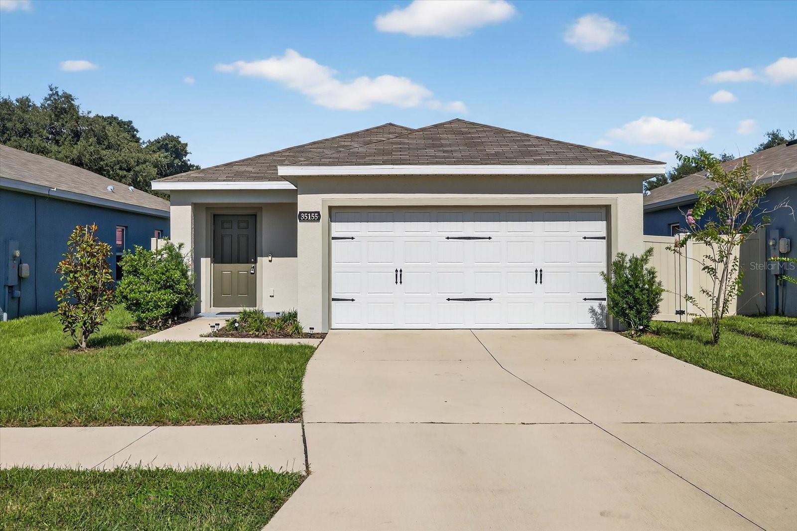 Why wait for new construction when this BARELY LIVED IN 2022 BUILD is ready for you NOW!! Welcome to 35155 Jomar Ave., Zephyrhills — a perfect mix of comfort, functionality, and location in a peaceful, private setting. This immaculate 3 BEDROOM, 2 BATH, 2 CAR GARAGE home is tucked at the rear of the community for EXTRA PRIVACY, right next to the DOG PARK with convenient OVERFLOW GUEST PARKING nearby. ALL FUNCTIONAL COMPONENTS LIKE ROOF, ELECTRICAL, AC, PLUMBING, STRUCTURAL IN MINT CONDITION!! Step inside to discover an inviting OPEN CONCEPT layout with durable, stylish tile flooring, ceiling fans throughout, and a modern kitchen featuring granite counters, stainless steel appliances, a large island bar, and a roomy pantry — ideal for both casual dining and entertaining. WASHER & DRYER is included. The primary suite is a true retreat with A HUGE WALK IN CLOSET and ensuite bath with. Two additional bedrooms are separated in this split floor plan for added privacy. Enjoy the outdoors in your fully fenced backyard. The LOW HOA FEE INCLUDES HIGH SPEED INTERNET AND BASIC CABLE through Spectrum, so you’ll never pay separate bills for those services. Perfectly located next door to SOUTHPORT SPRINGS GOLF & COUNTRY CLUB, where you can enjoy public GOLF, TENNIS, A HEATED POOL, CLUBHOUSE, BAR & GRILL DINING, and a full lifestyle program. Convenient access to I 75 takes you to Tampa or Ocala, and I 4 puts Orlando’s world class attractions within reach. Close to shopping, dining, hospitals, Wiregrass Mall, Tampa Premium Outlets, KRATE at The Grove, and the famous Sarah Vande Berg Tennis & Wellness Center! Seller is motivated — don’t miss your chance to own this like new beauty in one of the most desirable spots in Zephyrhills! ALL FINANCING TYPES ARE WELCOME, including but not limited to CASH, CONVENTIONAL, FHA, USDA, VA, DOWN PAYMENT ASSISTANCE — bring your offer today!