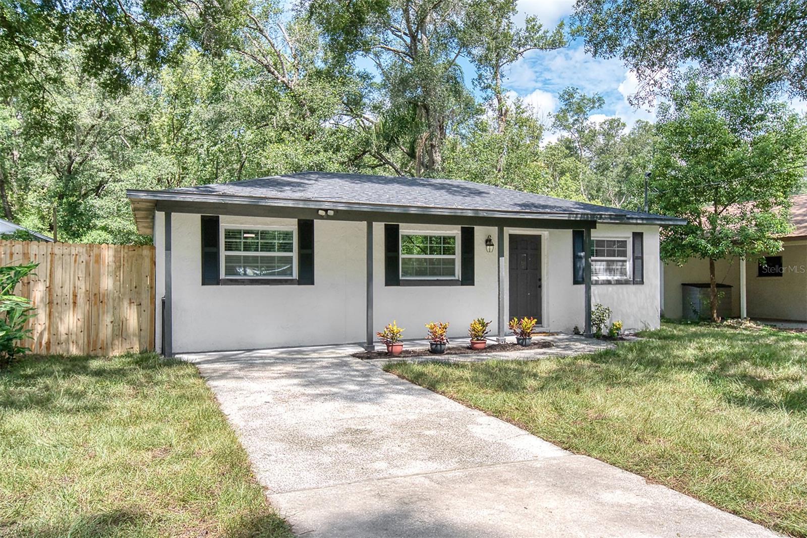 Closer than you would guess -- 4.5 miles to the 429, 15 minutes to downtown Mt. Dora and 23 minutes to Sanford Airport, this beautifully remodeled home offers solid construction with thoughtful, modern updates you’ll appreciate right away. With a brand-new roof (2024), newer A/C, updated water heater, new well, electric panel, and upgraded plumbing and electrical, the big-ticket items are already done for you. Inside, the open floor plan is bright and inviting, featuring stylish tile work, granite countertops, a spacious kitchen island, and plenty of storage. The oversized second bedroom is really two rooms in one—perfect for a home office, gym, in-law suite, or playroom and bedroom. Every room has modern ceiling fans to keep things cool, and you’ll love having an inside laundry room, screened back porch, and fully fenced backyard for pets, play, or relaxing evenings. Located in a quiet, established neighborhood with no HOA, this move-in-ready gem is the cutest home in the neighborhood and feels like home from the moment you walk in.