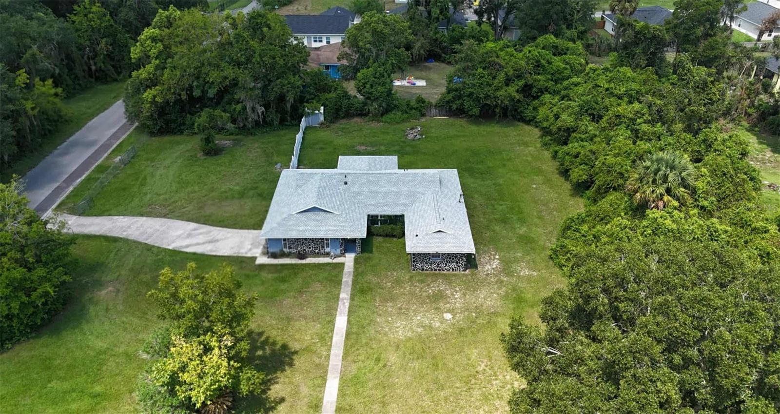 NEW ROOF and HVAC (2024). Check out this spacious 3-bedroom, 2-bath home on nearly an acre in Gainesville! The property is fenced with ample space to add a pool, storage, a workshop, or anything else that you may desire. Inside, you'll find two generous living areas, a formal dining room, and a spacious primary suite with a soaking tub and separate shower. Enjoy your mornings on the covered back porch overlooking the large backyard. A 2-car garage adds convenience, and with some cosmetic updates, this home could truly shine. Great opportunity - don’t miss it!