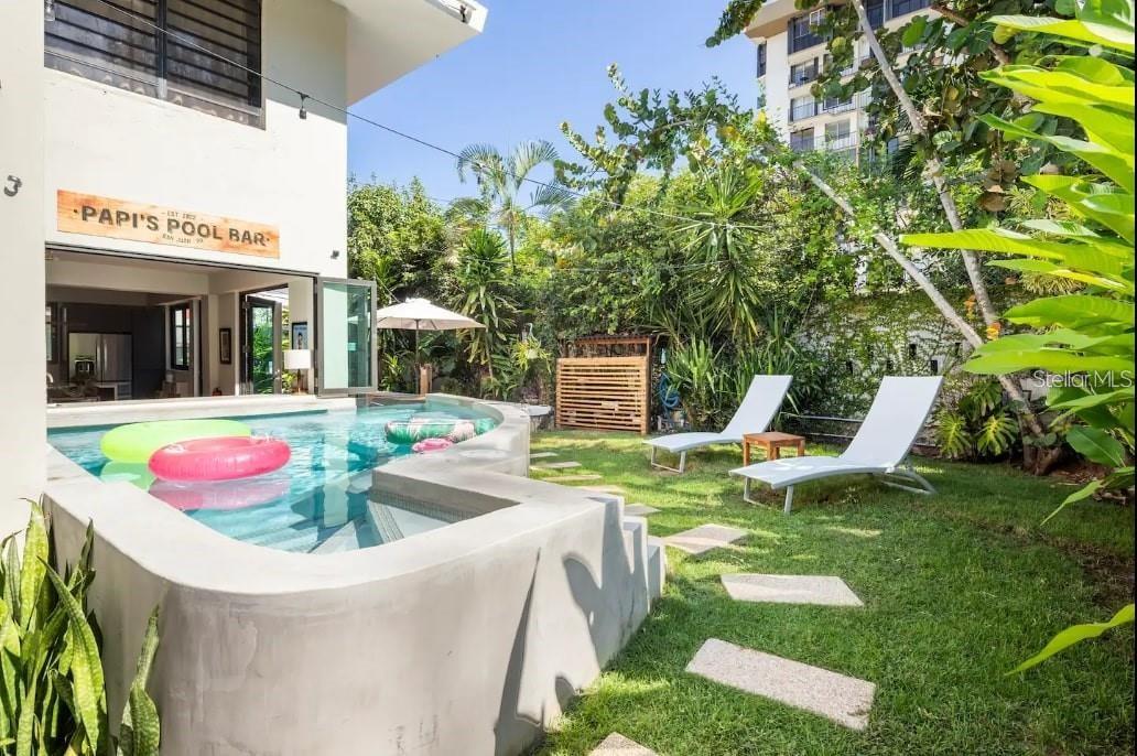 Tropical Retreat in the Heart of San Juan – Walk to Beach & Dining!
Welcome to your private oasis in San Juan! This beautifully designed home features a stunning plunge pool with built-in stools and a poolside bar, perfect for relaxing or entertaining. Just a short stroll to beaches, restaurants, and nightlife, the location offers the best of island living.
The King Suite is a true sanctuary, boasting a private patio with a double outdoor shower, lush tropical greenery, and hanging hammock chairs for the ultimate in relaxation.
Enjoy a fully equipped kitchen, backup generator for peace of mind, and spacious indoor-outdoor living surrounded by a lush green setting rarely found in the city.
Whether you’re seeking a serene escape or a stylish vacation rental, this one-of-a-kind home delivers.