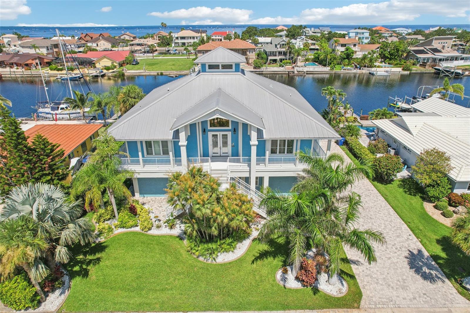 A once in a Lifetime opportunity to own a STUNNING CUSTOM BUILT Key West Style home with a SECURED GATED WRAP AROUND PORCH. Bring your YACHT, Flats Boat and Jet skis because this property has it all! Easily accommodate a 60+FT Yacht. Some key features on the Dock are a 50A Service, 8,000 LB BOAT LIFT and floating JET SKI DOCK along with a Fresh Water wash out. Ideal ACCESS to THE GULF provided by a 15’DEEP CANAL with NO FIXED BRIDGES!!! Within walking distance is the Gulf Harbors PRIVATE BEACH and optional membership to the Gulf Harbors YACHT CLUB as well.
Experience LUXURY COASTAL LIVING in this beautifully designed, custom waterfront home located on a quiet CUL-DE-SAC street with a SALT WATER POOL with PEBBLE TEC finish and for the PET Families you will enjoy the MAINTENANCE FREE ARTIFICIAL TURF for easy clean up along with a FENCED in YARD and DOC. You will appreciate the 30A service at the GARAGE enabling you to charge your RV or ELECTRIC CAR or The home also has a 15KW GENERATOR to power up the home in case of an outage. Enjoy your PAVER patio with the convenience of POWER SCREEN’S and a GRILLING Area while watching the Dolphins and Manatees or your evening SUNSET cocktail while listing to Jimmy Buffet on the BOSE SOUND SYSTEM..
Inside, you'll find upscale finishes throughout, including an ELEVATOR with NEW BATTERY backup, SOLID WOOD CABINETRY, premium GRANITE countertops, VIKING STAINLESS STEEL APPLIANCES, and PELLA IMPACT RATED WINDOWS with INTERNAL BLINDS & NEW PGT FRENCH DOORS for peace of mind. The open-concept main level features a LIGHTHOUSE STYLE entry way allowing plenty of NATURAL LIGHT and recently REFINISHED CHERRY WOOD FLOORS. The SPLIT FLOOR PLAN enables PRIVACY FOR THE 3 BEDROOMS, along with a dedicated OFFICE/FLEX room. Additional features include A GAS FIREPLACE in the family room, separate BAR with Mini Refrigerator and Sink, CENTRAL VACCUM, upgraded WATER SOFTENER and a GAS TANKLESS WATER HEATER. The East and West windows of the home were also tinted in 24' for energy efficiency which helps to save money monthly on the electric bills.
Downstairs, a fully equipped GUEST SUITE or IN-LAW SUITE awaits—complete with a KITCHENETTE and 4TH FULL BATH with a separate exercise/storage room with a SPLIT A/C room for added flexibility. You can easily convert this into an apartment with private access. Additionally the CAR ENTHUSIAST will love the 6 CAR GARAGE. The garage includes a 3rd bay/man cave separate setup.
Close proximity to shopping, dining, grocery, and everyday conveniences
This home offers a rare blend of luxury, function, and WATER FRONT LIFESTYLE. Schedule your private tour today!