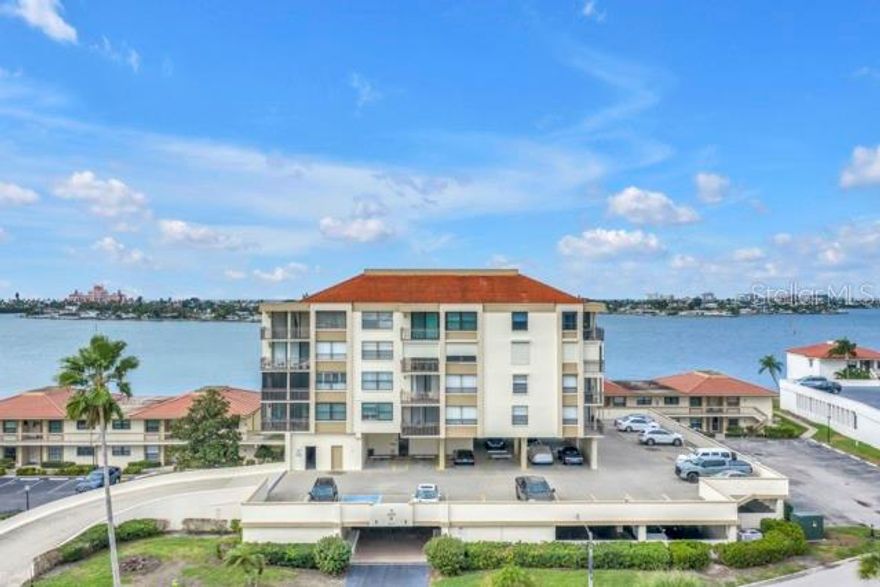Come live the tropical island lifestyle on Isla Del Sol.   Located in close proximity to the Isla Del Sol Yacht and Country Club and just a short walk to St Pete Beach and the Don Cesar Resort.  This attractive condo is a corner unit that is light and bright and tastefully updated; including ceramic tiled floors throughout. The kitchen features updated cabinetry, newer appliances and granite counter tops while the bathrooms have been remodeled with updated tile work and vanities.  The master bedroom offers a large, walk-in closet and a linen cabinet, for extra storage.  The guest bedroom is spacious and includes two generous closets.  There is also a laundry closet in the unit, with a stack washer and dryer for extra convenience.  This unit is being sold with the current furniture and is turn key ready for a new owner.  Covered parking space #136 and storage space #136 are included with the unit.  The community resort style pool is located directly on the Boca Ciega Bay for enjoying beautiful water views and sunsets.  The walkability or biking on beautifully landscaped Isla del Sol is exceptional.  There is also ready access from the island to St. Pete Beach, Ft. Desoto Park or I275 for a quick trip to vibrant downtown St. Pete.  Don't miss this opportunity to own your piece of paradise.