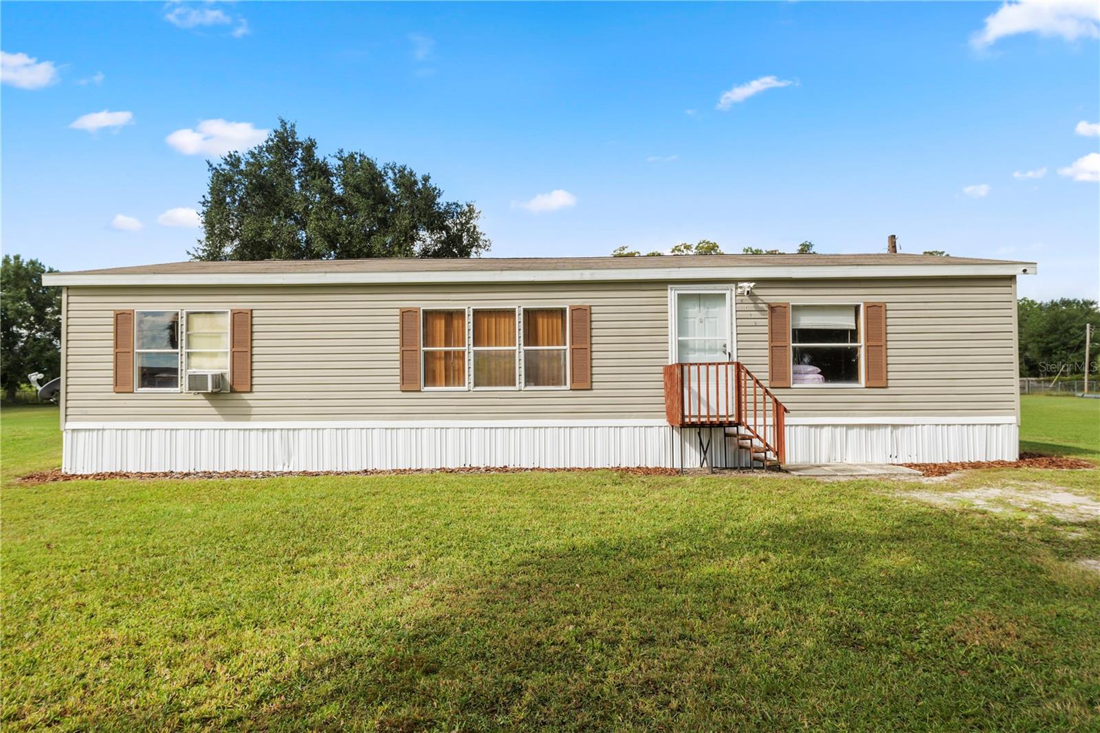 Take a look at this 3 bedroom 2 bathroom home sitting on close to 2 acres of HIGH and DRY land with NO HOA! This property is fully fenced in for your privacy. Inside, you’ll find a spacious living room with vaulted ceilings that leads into your open kitchen and dining area. The kitchen features plenty of cabinet and countertop space as well as a breakfast bar for those quick morning meals. The primary bedroom offers plenty of space and features an en suite bathroom with a single sink vanity, stand up shower and walk-in closet, the en suite also provides access to your inside laundry room. The remaining two bedrooms are generously sized, each with their own walk-in closet and share the main hall bathroom featuring a single sink vanity and tub/shower combo. Outside, you’ll find a storage shed and basketball goal along with plenty of beautiful land to enjoy! This home has so much to offer. Schedule your private showing today!