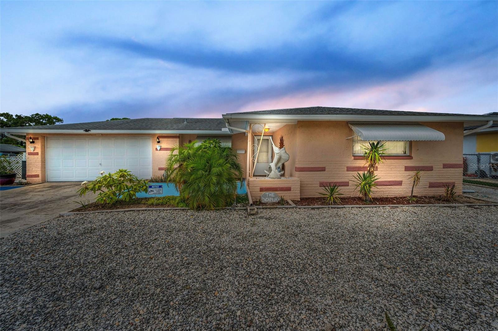 Welcome to this beautifully maintained 2-bedroom, 2-bath home featuring an open floor plan and desirable indoor/outdoor living. Step inside to discover tile flooring throughout, a spacious living and dining area, and an updated kitchen with abundant cabinetry, tile backsplash, and flooring—perfect for entertaining or everyday living.
Sliding doors from the living room open to a covered lanai and screened-in pool area, ideal for enjoying Florida’s sunny lifestyle. The private, fenced backyard is adorned with tropical, low-maintenance landscaping for a serene outdoor space.
The generous primary suite offers an ensuite bath, while the guest bedroom is equally spacious with easy access to a large guest bathroom. Additional highlights include a tiled front porch, 2-car attached garage, and a layout designed for comfort and functionality.
Conveniently located near shopping, dining, and medical facilities—this home has it all. Don’t miss out—schedule your private showing today!