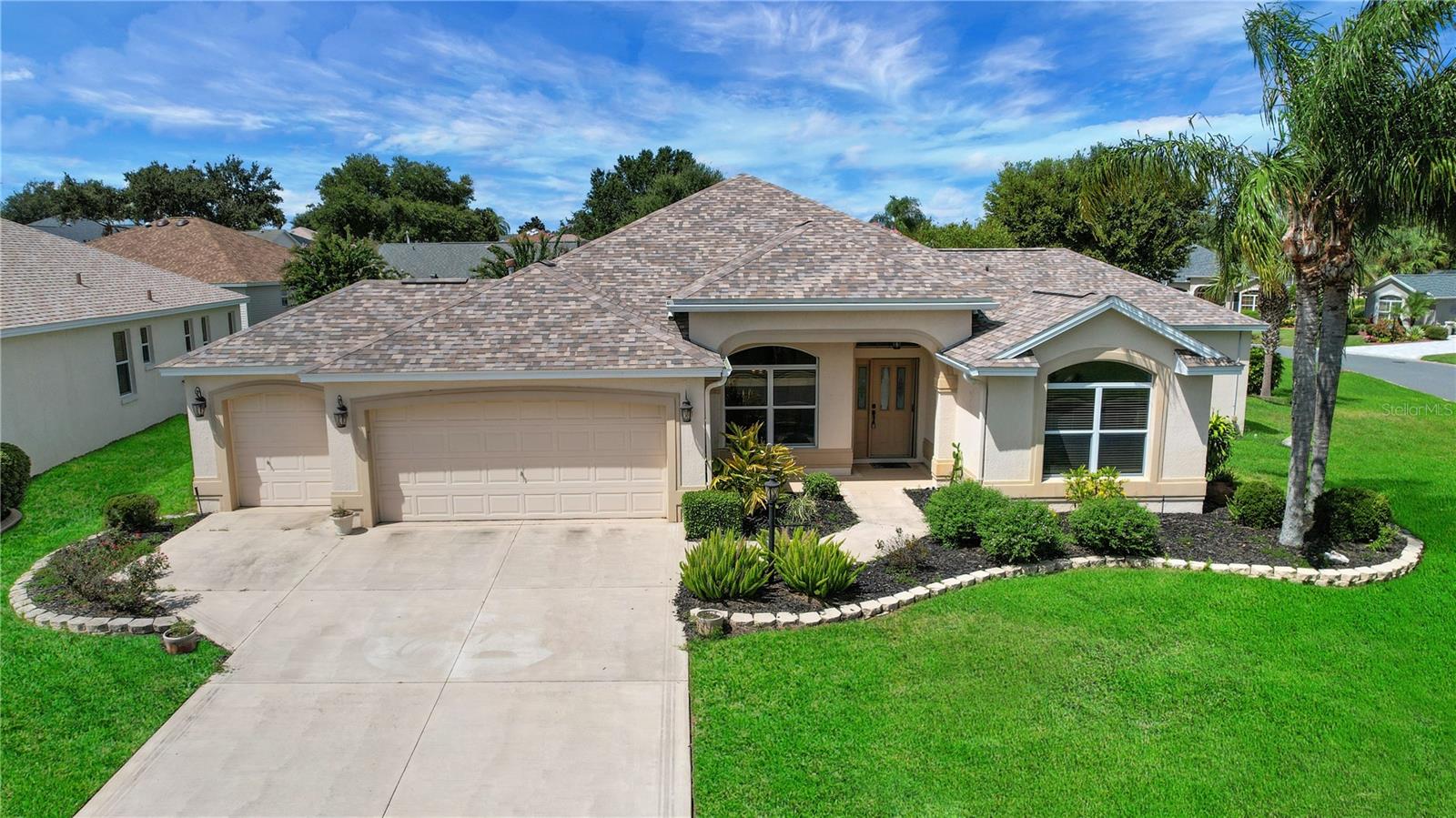 Welcome to this beautifully expanded Gardenia model in Sunset Pointe in The Villages. This 4-bedroom, 3-bathroom block/stucco home with 2 car + GOLF CART garage offers 2,407 sq. ft. of living space on a 0.24-acre corner lot. The open floor plan and expansive lanai with summer kitchen make it perfect for entertaining family and friends. Inside, soaring ceilings create a bright, airy atmosphere. The kitchen features a breakfast bar and nook, ideal for casual dining. The primary suite is generously sized and boasts an ensuite bathroom with tall countertops, dual sinks, and a private water closet. The spacious second primary/in-law suite features vinyl plank flooring, its own ensuite bath with a walk-in shower, new cabinets, and a quartz countertop. Recent updates include a new roof and water heater (2023) and a new HVAC system (2018). The home is equipped for both gas and electric utilities and carries a low bond balance of $5,927.51. Conveniently located between Lake-Sumter Landing and Brownwood, near shopping, dining and entertainment, this home offers the perfect blend of comfort and lifestyle. Schedule your private showing today!
