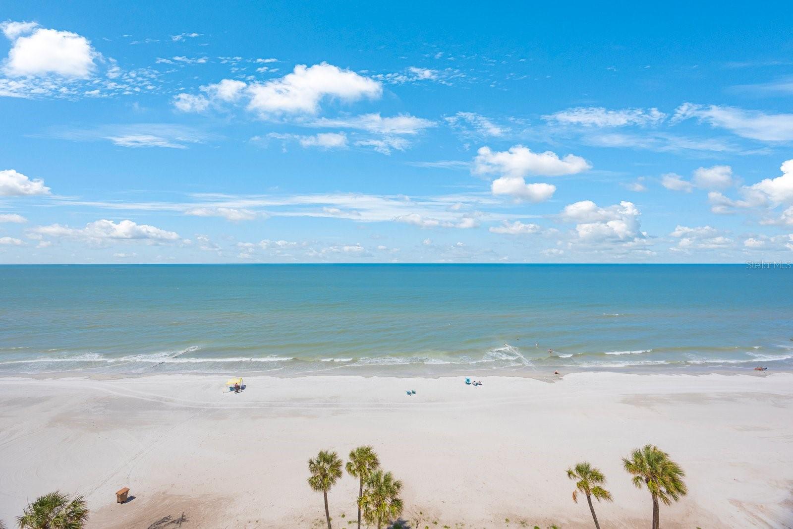 Welcome to your Slice of Paradise! This completely renovated 2-bedroom, 2-bath Gulf Front Condo located in highly sought-after Ocean Sands offers the ultimate beachfront lifestyle. Sold fully furnished with future rentals in place, this condo is is perfect as an Investment, Second or Primary Home or a 1031 Tax Deferred Exchange.
Step inside and experience a Complete Renovation with High-End Finishes. This open-concept living space offers coastal-chic décor, luxury vinyl plank flooring, designer lighting, custom cabinetry throughout and interior laundry. The gourmet kitchen features quartz countertops, stainless steel appliances, and a large breakfast bar that’s perfect for entertaining. A direct Gulf front primary bedroom boasts triple back sliders to let in those cool evening breezes and offers privacy with its completely renovated en-suite bathroom and huge walk-in closet. Guests will appreciate the second bedroom complete with one king and one queen bed with access to the renovated full bath in hall. Spend time with family and friends on the 30-foot-wide private balcony with breathtaking, unobstructed view of the Gulf of Mexico—perfect for watching sunsets, entertaining or just relaxing to the sounds of the waves. Carrier A/C unit and new water heater installed less than two years ago, storm rated windows and storm shutters provide peace of mind and energy efficiency.
Enjoy resort-style amenities, including a heated beachfront pool and spa, shuffleboard courts, bike room, BBQ grill area and a cozy tiki hut—all just steps from the sand. For your convenience, the unit includes underbuilding parking space # 30, located close to the lobby entrance, plus a private second storage closet near the elevators on the 9th floor.
Madeira Beach is full of easy to get to activities. Leave the car behind and enjoy nearby ROC Park Entertainment Venue with recreational activities, ball fields, basketball and tennis courts, a dog park and fishing pier. Catch some live music at one of the local bars or visit the Cambria Hotel for dinner and drinks on the rooftop deck. Take a trolley to Famous John’s Pass Village and enjoy the extensive watersports rentals or visit the shops and restaurants. Take the Beach to ‘Burg SunRunner and spend the day in Downtown St. Petersburg visiting the local Arts District, upscale dining, craft breweries, museums and the St. Pete Pier. Orlando/Disneyworld just 90 minutes away; Tampa International Airport about one half hour away.
Whether you’re looking for a personal beach retreat or an income-producing property, this unit delivers both. Take advantage of this rare opportunity to own a one-of-a-kind beachfront condo in one of Madeira Beach’s most desirable communities. Paradise awaits at Ocean Sands!