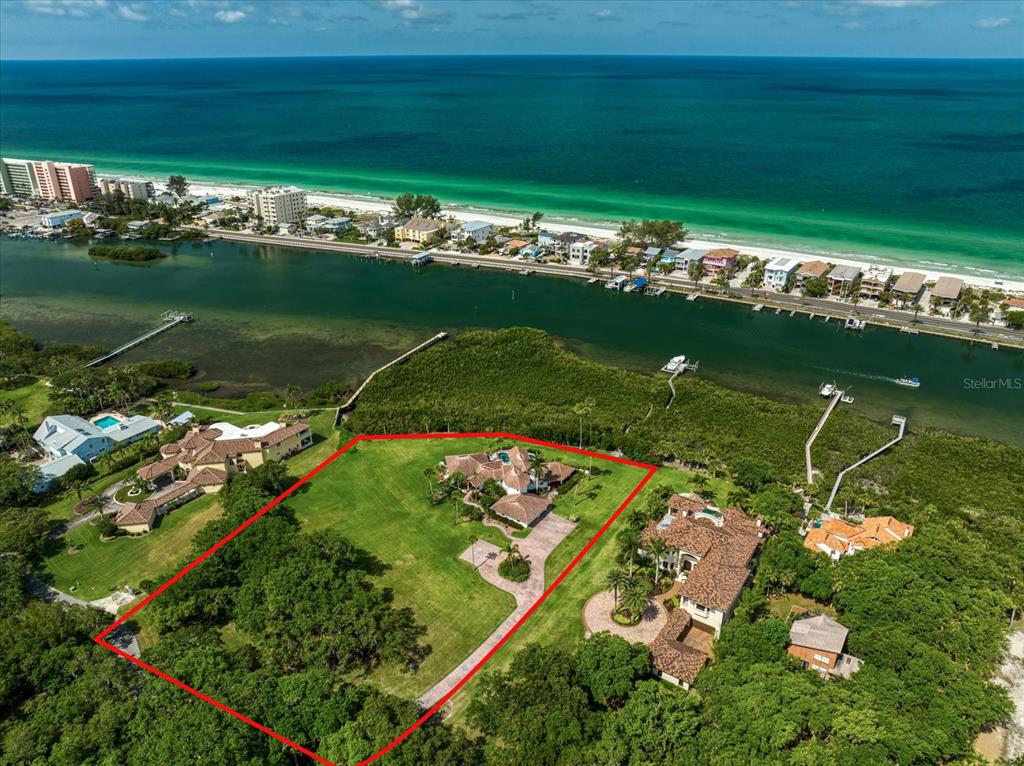 Under contract-accepting backup offers. Rare! Estate property with two expansive acres on the intracoastal waterway! This 4 bedroom, 4.5 bath pool home is situated along the waterfront. Once you drive up the tree-lined, private road to this property you are greeted with a beautiful fountain and koi pond. The first floor features a kitchen with wood cabinetry with custom glass inserts, stone countertops and stainless steel appliances. The kitchen features an island and a cozy breakfast nook The living room features a vaulted wooden ceiling with access to a covered porch that overlooks this gorgeous property. This level also includes a dining room, formal living area and 3 more bedrooms each with en-suite baths. The second floor boasts a large primary bedroom with a generous bath and separate tub and shower. This level has a private balcony overlooking the pool and the beautiful westerly views. The composite dock includes power and water with a lift and a wet slip. Bring your boats, paddle boards, jet skis, kayaks and fishing rods! The 3 car garage includes an air conditioned workroom. Golf cart to the beach and fine dining including waterfront restaurants! This unique property has R-R Zoning, therefore, horses and other farm animals are permitted. There are so many possibilities here--must see to appreciate all the offerings of this estate!