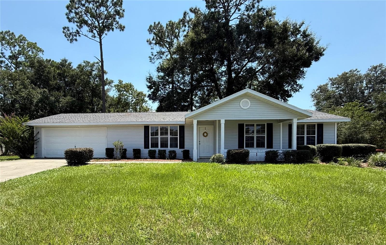 This move-in ready expanded Hampton model sits on a rare .32-acre lot in the desirable 55+ community of Oak Run and features a newer roof completed in 2020 for peace of mind. Inside, you’ll find high ceilings, a spacious eat-in kitchen with a dedicated dining area, tile flooring throughout the main living spaces, and carpet in the bedrooms. The large master suite includes a generous walk-in closet, and all appliances, including the washer and dryer, are included. The oversized two-car garage with automatic garage door opener provides laundry space and extra room for projects. Enjoy mornings on the welcoming rocking chair front porch or relax and entertain in the large screened-in porch overlooking a private backyard with mature trees. Nestled in a quiet part of the community with gated security and easy access, this home is close to everything Oak Run provides, multiple clubhouses with fitness centers, swimming pools, spas, and community rooms; recreational facilities like tennis, pickleball, shuffleboard, and bocce ball courts, as well as a golf course with a restaurant and a driving range. Other amenities are a library, ceramics and craft studios, a ballroom, a dog park, and a recently renovated, on-site restaurant called the Oak Room Bar and Grill. near excellent healthcare and shopping. Nearby medical options include HCA Florida Ocala Primary Care, Quick Care Med Urgent Care, and TimberRidge Imaging Center, with AdventHealth Ocala Hospital just a short drive away. Residents also enjoy close access to grocery stores such as Publix, Walmart, and Aldi, making daily errands quick and easy. This home is clean, inviting, and ready for its new owners.