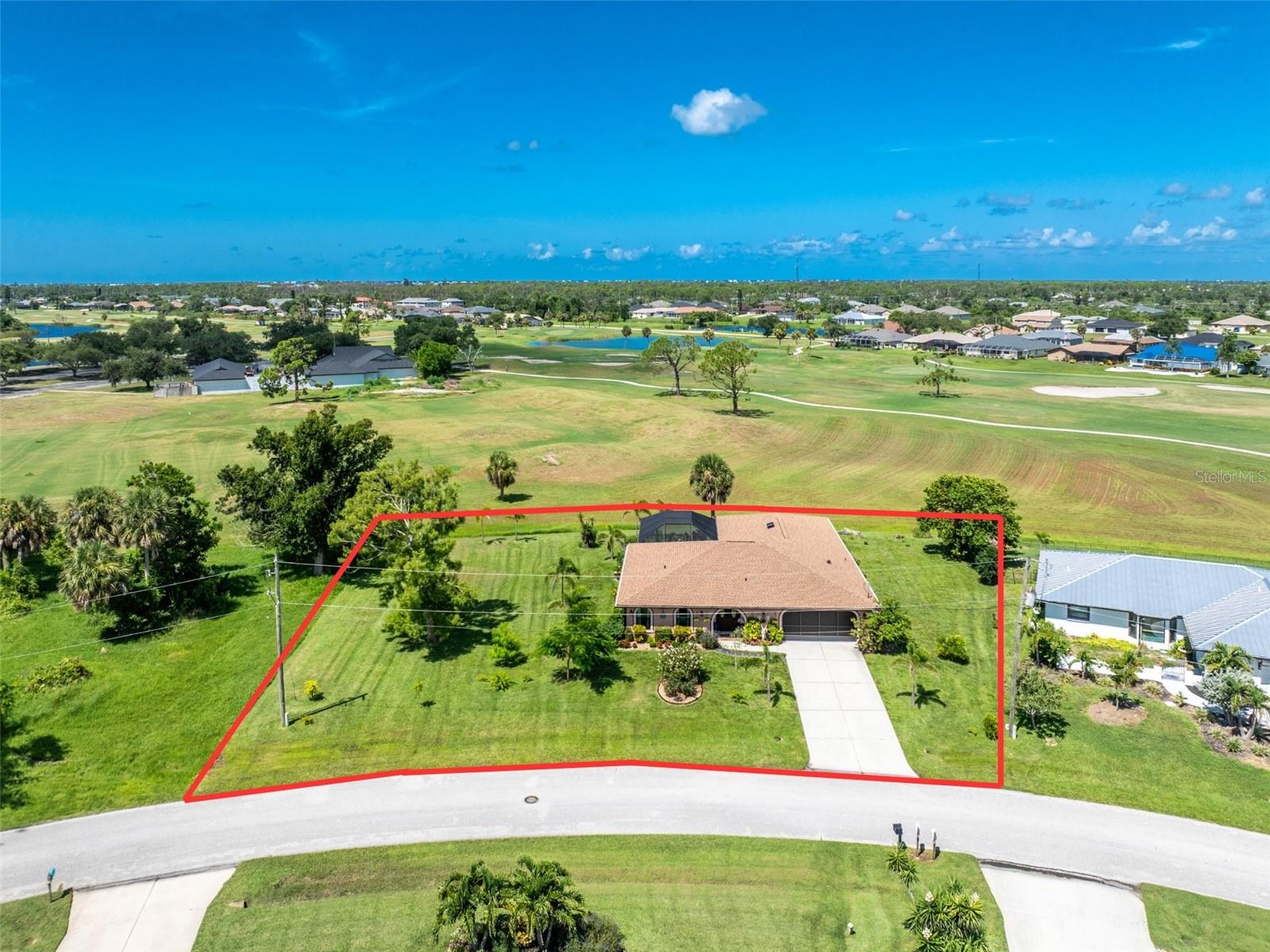 Experience the ultimate Florida lifestyle in this stunning home located directly on The Palms golf course in Rotonda West. You'll instantly fall in love with this inviting three-bedroom, two-bathroom pool home, perfectly situated on an expansive double lot with mature landscaping. Impressive curb appeal is highlighted by the arched entryway, screened garage door, and charming brick accents surrounding the double-door entrance. Once inside, you're greeted by large, uniform tile flooring, decorative chair railing, vaulted ceilings, an electric built-in fireplace, and pocket sliding glass doors in the formal living area. The beautifully remodeled kitchen (2023) seamlessly opens to the family room and features white shaker-style cabinetry, a contrasting gray island with soft-close drawers, quartz countertops, and an elegant glass tile backsplash. Upgraded lighting fixtures and stylish wall colors add a modern, sophisticated touch. The thoughtfully designed split floor plan offers exceptional privacy, especially in the master suite, where you'll wake to breathtaking views of the pool and golf course through pocket sliding glass doors and has dual walk-in closets, and an ensuite bath featuring a large soaking tub, dual-sink vanity, and a glass-enclosed walk-in shower. Guest bedrooms are generously sized, each with reach-in closets, and the guest bathroom includes a convenient shower/tub combination. Outside, your dream Florida retreat awaits. There is a great pool with waterfall feature, a uniquely decorated ceiling on the covered section of the lanai, and screened enclosure to ensure your sparkling pool remains pristine year-round, all overlooking the beautiful golf course. Additional upgrades include impact-resistant windows, front doors, and garage door (2023), tankless water heater, shingle roof with solar-powered roof fan (April 2023), gutters, soffits, and downspouts (2023), central vacuum system, and spray foam attic insulation (2023). Rotonda West is a vibrant, deed-restricted community offering abundant activities and amenities. Whether golfing on one of the community’s five courses, enjoying nearby pristine beaches like Englewood and Boca Grande, exploring local marinas, or dining and shopping, there’s always something to do. Spend leisurely days relaxing with a book, floating in your pool, or working on projects in your screened garage. In the evenings, rinse off after a beach day, enjoy dinner with neighbors at the community clubhouses, or fire up the grill and unwind on your lanai. Don't miss this exceptional opportunity at 30 Bunker Lane, call today to make this your new home!