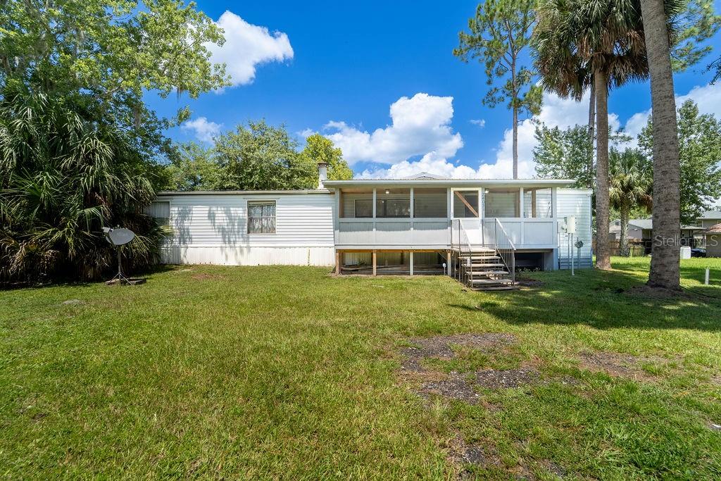 Spacious double-wide manufactured home with 1,864 sq. ft. of living space just minutes from the beautiful St. John’s River! This home offers a large living area, an eat-in kitchen, and a formal dining room—perfect for family gatherings or entertaining. The primary suite boasts a huge master bathroom with a garden tub, separate shower, abundant wood cabinetry, and a walk-in closet. Three additional bedrooms, a second full bath, an inside laundry room, and a cozy wood-burning fireplace add to the home’s comfort and functionality. Best of all, this property sits on your own land with no HOA or deed restrictions. For just $40 a year, you’ll enjoy access to the community boat ramp for easy trips to the St. John’s River. Don’t miss this opportunity to own a spacious home near the water with freedom and convenience!