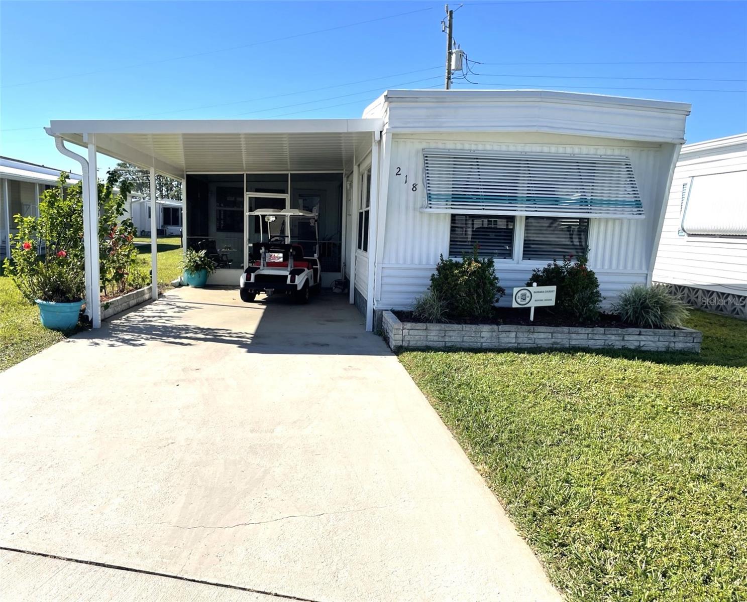Adorable, warm and welcoming cottage like manufactured home in the popular boating community of Harbor Cove. Low $99 annual HOA fee! Located in the pet friendly section for your furry friends. Enjoy a myriad of activities and amenities, including a marina and boat launch. Pride of ownership is obvious throughout. Carport and lanai screen room replaced 2023. New exterior skirting 2023. A/C replaced December, 2009. Roof is metal and was installed prior to the current owner approximately 10 years ago. The roof has never leaked. The home is being offered turn key furnished. Enter the home into the kitchen/Living room combo that is bright and airy. Wood kitchen cabinets with plenty of counter space and storage. Luxury vinyl in kitchen, hallway, bathroom and bedrooms. The bathroom has been updated with shower, dual sinks, counter and lighting. Lovely Florida room with tile flooring is a great space to hang out with a good book or your favorite libation! Great opportunity to own your slice of paradise on the sun coast of Florida! Don't miss taking a peek at this home, it won't last long. Call today for your private tour.
