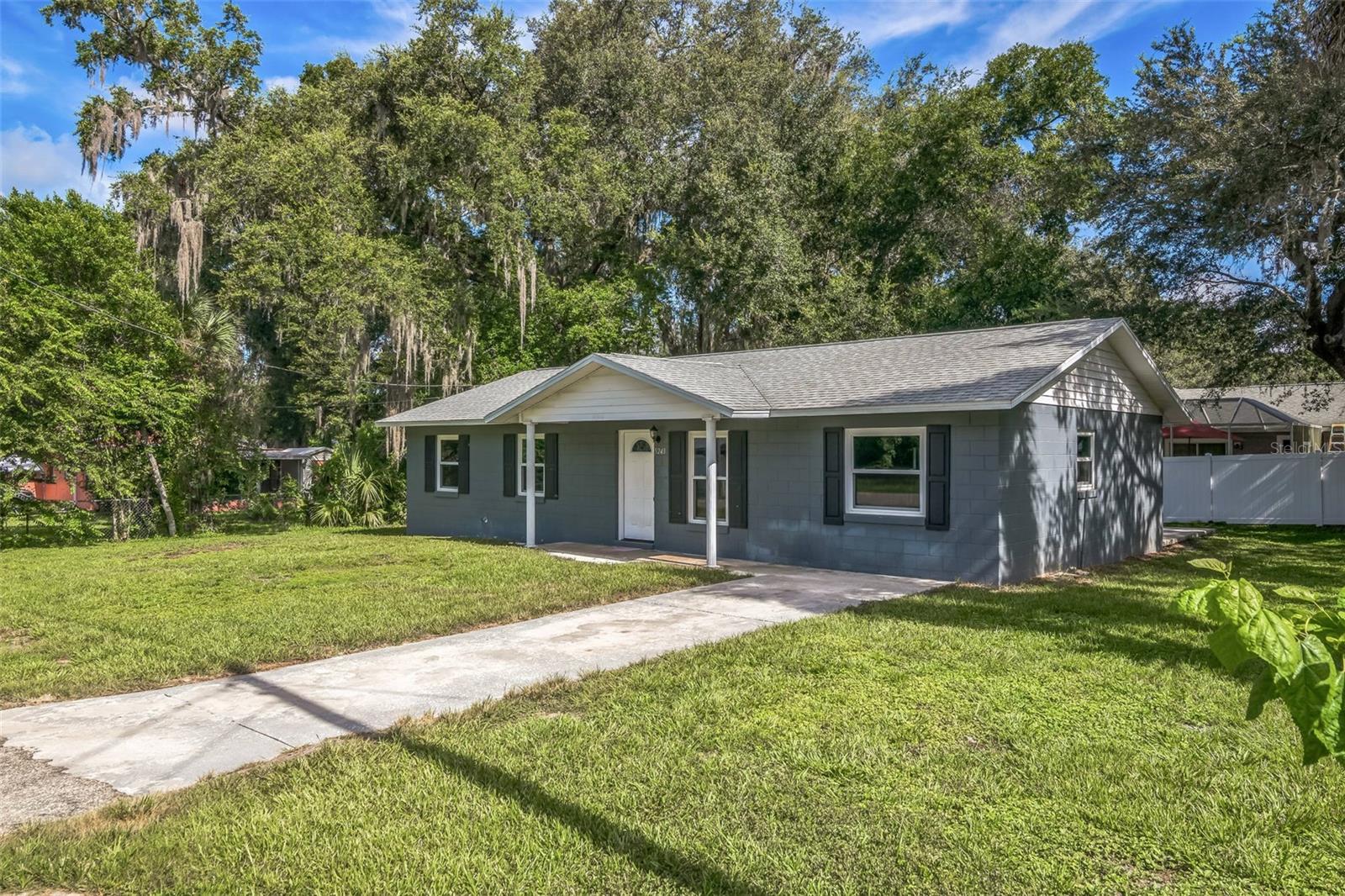 Welcome to this charming 3-bedroom, 2-bathroom single-family home offering 1,248 square feet of comfortable living space on a spacious 7,405 sq ft lot. Built in 1977, this well-maintained residence blends classic design with modern updates, creating a move-in-ready retreat in the heart of Belleview. Step inside to an open living and dining area with abundant natural light and low-maintenance flooring throughout. The kitchen features rich dark cabinetry, a tile backsplash, and essential appliances, with a breakfast bar perfect for casual meals. The floor plan includes a primary suite with an en-suite bath and two additional bedrooms, one with custom corner shelving for added functionality. Outside, enjoy a large front yard, a concrete driveway, and a covered entry porch. The backyard offers a shaded patio and mature trees—ideal for relaxing or entertaining. A dedicated laundry room with washer/dryer and extra shelving adds convenience. Centrally located near shopping, dining, and schools, this home is perfect for first-time buyers, downsizers, or investors seeking a solid rental property.