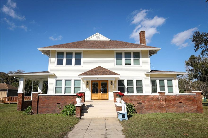 This beautifully maintained historic home sits on over an acre of land in the town of Sanford and is ready for its next owner. Offering more than 2,600 square feet of timeless character and comfort, this charming two-story residence welcomes you with an inviting front porch and rich sense of history. Inside, you step in the bright and spacious main living area with hardwood floors, a gas fireplace, and abundant of bright natural light. French doors connect the living room to a formal dining room on one side and a private sunroom, ideal for a home office or playroom, on the other side. The large, light-filled kitchen is the heart of the home, featuring a gas range, double sinks, wood cabinetry, tiled counters, a breakfast nook, and built-in storage. The first floor includes a primary bedroom with custom built-in cabinets and a private bath, while the second floor offers three additional bedrooms, a shared bathroom, and a bonus room. Ample closet space and large linen closets provide excellent storage throughout. Just off the kitchen, the laundry room and rear entrance lead to a spacious screened porch and deck overlooking the expansive backyard—perfect for morning coffee, entertaining, or relaxing outdoors. The property also includes a fire-pit, a detached workshop with electricity, and a large storage shed. Recent updates include a new roof, windows, HVAC system, electrical panels, gutters, front double wood doors, and septic pump. An active termite bond and animal protection trenching offers added peace of mind. Also, the property is zoned A-1 for agricultural which means you can have barn animals such as chickens, goats, cows and horses. Ideally located, the home is close to downtown Sanford’s shops, restaurants, coffee spots, farmers market, and year-round events, with direct access to the Lake Monroe bike and walking trail right out front. Publix and gas stations are within two miles, and major highways and Orlando Sanford International Airport are just minutes away. Homes like this rarely come available—don’t miss your chance to own this unique historic gem. Schedule your showing today.