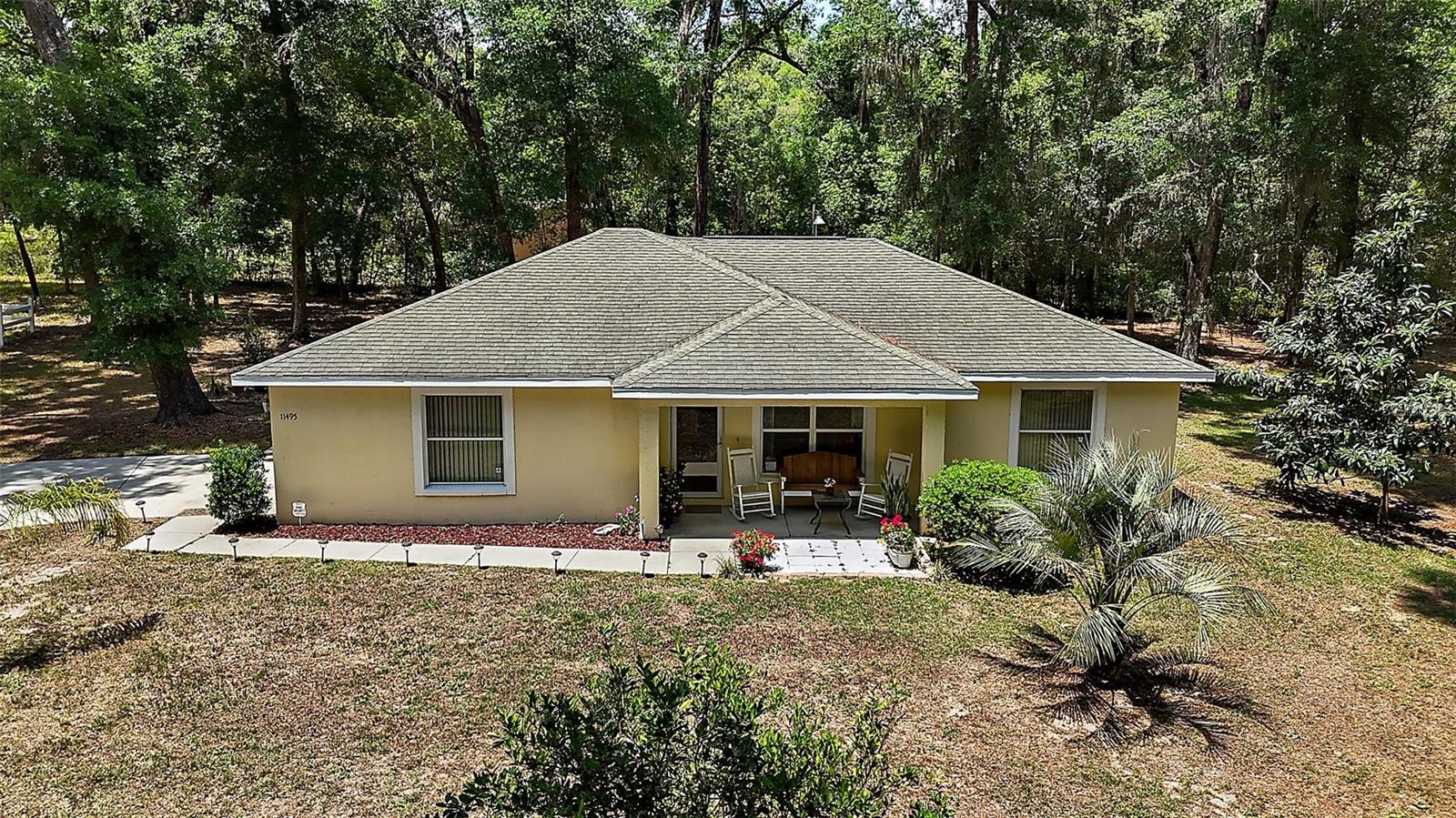 The Florida room could easily be under ac and adds 280 sq. ft. Make it another bedroom with an ensuite! Per the county, you can build another home on this property! Nestled in along a dirt road you will find this peaceful property. Want to get away from it all but yet be 5 minutes from Downtown Belleview? Family Homestead? This beautiful home has right under 4 acres of property to do as you please. Did I mention it has a barn with a workshop on it too? Come build your garden, have plenty of room for your animals to roam, or just enjoy the unique birdlife from your front porch. The Florida room is oversized for all your entertaining. Or, wind down at night with the cool breeze coming from surround windows. The kitchen has plenty of space for 2 chefs to cook along with a very large in room dining space to eat. The primary bathroom has a large walk in shower, two sinks and an additional linen closet. Come reap the harvest of fruit trees planted long time ago and start your own dream farm on this secluded but not isolated property. The Tractor and trailer are negotiable along with the furniture in the home. The opportunity is endless. Ask me about seller concessions too.