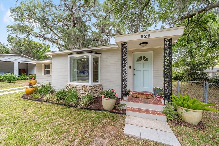 This charming home near downtown Ocala has been tastefully transformed and well loved! Located in the golf cart district and within approximately 1 mile of everything downtown has to offer, including dining, the farmers market, entertainment, Marion Theatre, shopping, the monthly art walk, and a variety of community events. With 2 bedrooms and 2 full bathrooms, this is ready for you to call home, or it can make a great short-term rental. The open concept living area showcases a deep-set bay window, perfect for cozy reading or displaying plants. With ample room for a dedicated dining area, this space is ideal for both everyday living and entertaining. For added functionality, a beautiful barn door separates the living space from the classy workspace with a built in desk, shelves, and drawers.  Fall in love with this designer-inspired kitchen! This bright space features custom two-tone cabinetry with soft-close doors and drawers, accented by a beautiful hexagon tile backsplash and under-cabinet lighting. Complete with granite countertops, a full stainless steel appliance package, and matte black fixtures, this kitchen is as functional as it is stylish. This split floor plan places one bedroom and one bathroom on each side of the home for added privacy. One beautifully renovated bathroom includes a custom vanity with a designer vessel sink and waterfall faucet, a sleek LED-backlit mirror, patterned tile flooring, and a shower/tub combination with classic subway tile. A smart control exhaust fan featuring integrated lighting, and built-in Bluetooth speaker allows you to stream music or audio for a spa-like experience. On the opposite side of the home, the second bedroom has a built in desk and an updated ensuite bathroom.  Outside, the spacious yard is fenced with a private rear alleyway and no direct rear neighbor. Recent updates include AC (2023), water heater (2020), roof (2012), newer windows, and plumbing re-piped approximately 2013. Additional improvements include flooring, paint, textured ceilings, fixtures, and a new bay window.