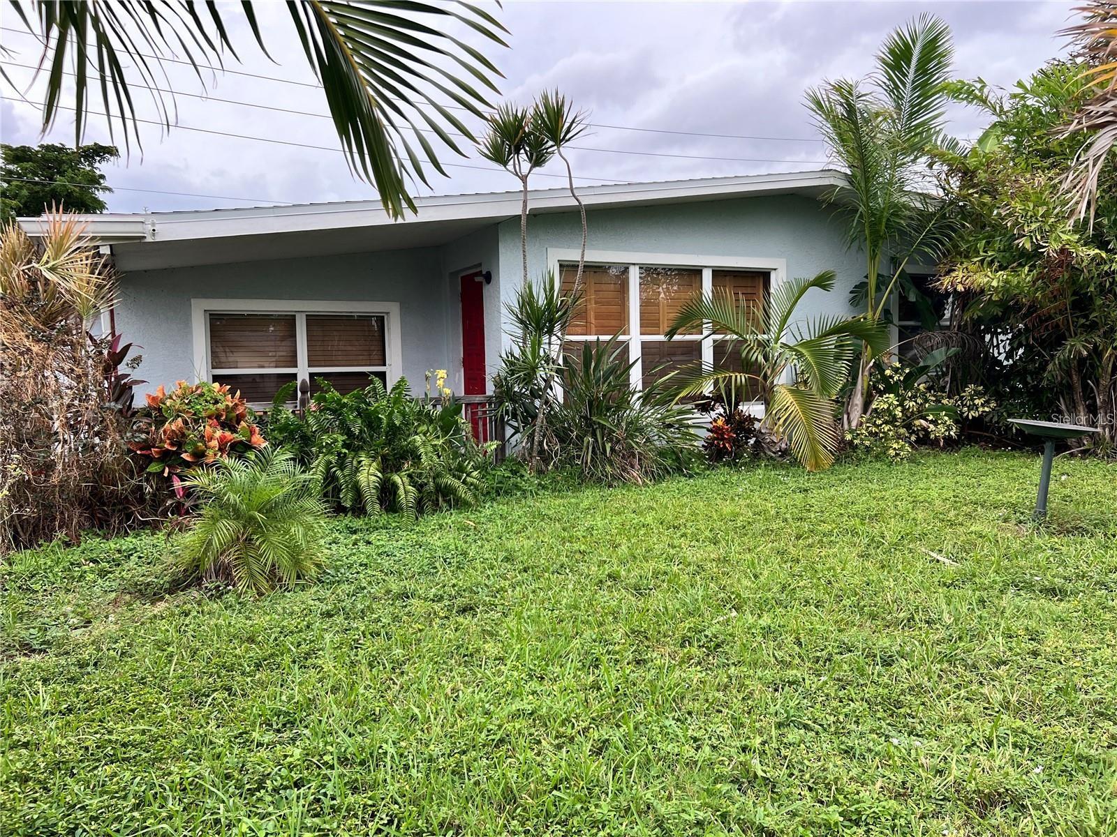 Welcome to this beautifully maintained 3-bedroom, 2-bathroom home with a bonus room, offering endless possibilities! The third bedroom, currently set up as an office, can easily be converted back to a bedroom, creating a flexible space for your needs. Recent upgrades include a 2022 AC, newer roof, and a brand-new water heater, ensuring comfort and peace of mind. Outside, enjoy a new back porch deck overlooking a lush, tropical oasis backyard, complete with fresh fencing for privacy. For those with an RV or boat, a 240 RV hook-up, concrete parking slab, and double driveway make storage a breeze. Inside, the updated kitchen shines with newer appliances, including a refrigerator. Conveniently located close to shopping, schools, beaches, and downtown, this home combines modern amenities with a prime location. Don’t miss the chance to make it yours!