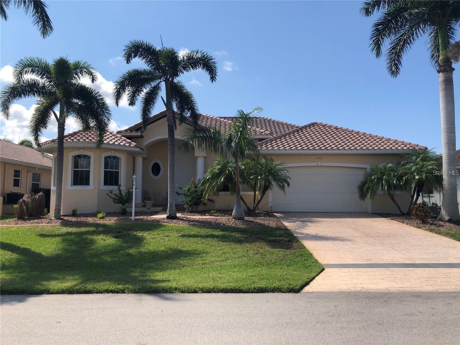 Impressive WATERFRONT custom 3 Bedroom Plus Den/Office, 2 Bathroom home with attached oversized 2 Car Garage. Built by FeroConstruction. Located on a quiet cul-de-sac street in desirable deed restricted PUNTA GORDA ISLES. This home offers SAILBOAT ACCESS (nobridges) to Charlotte Harbor and on to the Gulf of Mexico. 45 foot concrete dock with water and electricity and 80 foot concrete seawall. Thisstunning light and bright home offers an open and split bedroom floor plan with Great Room, separate Dining Room, well appointed Kitchen,Inside Laundry. Features include Italian porcelain tile floors in the living areas, high ceilings, Dining Room with tray ceiling and crown molding,zero corner sliding glass doors. custom wrought iron railing, manabloc plumbing, water softener, tankless water heater, workshop area in thegarage, transom window over the front door. The following items convey with the house: kitchen table, breakfast bar stools, entertainmentcenter in the Great Room. The Kitchen offers stainless appliances, granite counters, 42 inch white cabinetry, tile backsplash, breakfast bar,swanstone sink, pantry closet and dining area overlooking the pool and water. The Laundry Room has front loading washer and dryer, storagecloset, utility sink. The Master Bedroom suite features zero corner sliding glass doors, huge custom closet with access to the laundry room, dualsinks, large walk in shower and clawfoot soaking tub. Three steps take you to the guest area. There are two large guest bedrooms and the guestbathroom has a tub/shower combo and granite counters. The spacious Den/Office has a private balcony and French doors open to overlook thecovered lanai. Your living space extends to the screened lanai with heated inground saltwater pool, outdoor shower, covered area and plenty ofopen deck for sunbathing. Utilities are city water and sewer. Storm protection includes hurricane shutters and impact windows. NEW tile roof2023, NEW tankless hot water heater 2020, NEW owned water softener 2021, NEW pool heater 2018, NEW pool screens after hurricane Ian2022. This home is minutes from historic downtown Punta Gorda shopping, dining, medical care, waterfront parks, boat ramps, fishing piers, artgalleries, walking and biking paths, weekend farmers markets, Fishermen's Village, events and more!