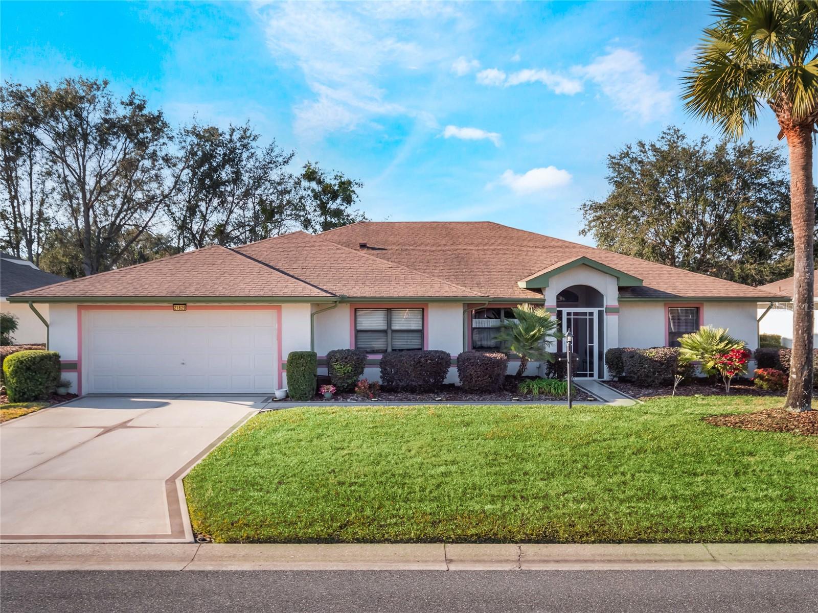 One of a kind Modified & Expanded Majestic Model with CUSTOM improvements and updates throughout! Situated on an oversized lot with water views, this 2684 square foot home has a large garage with a workbench & cabinets/racks, epoxy floor, and auto screen! Peace of mind is YOURS with a 2023 GENERAC *Whole house back-up*, Natural Gas Generator, 2025 ROOF, 2023 Gas Water Heater, CENTRAL VAC, and 2013 HVAC-all maintained and routinely serviced! Inside, you'll fall in love with the updates this home has received, including the engineered flooring, Quartz counters & sills, fully renovated kitchen with cottage-style beadboard cabinets, full wall of pantry cabinetry, pull-outs, island, media center, stainless appliance package (with a gas line behind the range for easy conversion!) and a show-stopping glass backsplash! The split bedroom floor plan offers HUGE bedrooms, large closets for storage, access to the Florida Room & Lanai areas, and the Primary Suite includes a sitting area for quiet reading or can be used by those still working from home as an office space, just use your imagination! And, WOW! The primary bathroom has been renovated into a serene oasis with free-standing modern tub, walk-in shower with glass enclosure surround, rainshower head, and Quartz vanity counters. The herringbone tiled floor is magnificent! This home has so many considerations for it's owners including a craft room or Butler's Pantry, additional closet storage, a HUGE air-conditioned Florida Room, and expanded screen lanai with fountain! Gorgeously landscaped all around, with a pond full of fish! Toss a line in from the water's edge! Explore all Royal Highlands and Lake County Florida have to offer! This home is being sold mostly furnished and turnkey! The skylights offer a ton of natural light and the shelter room provides a safe place for owners and pets. The vaulted ceilings give this beautiful home an expansive feel and is the perfect home for entertaining. Knockdown ceiling texture, orange peel walls, bull-nose corners, and surround sound! The recirculation pump provides the home with instant hot water! This property is a MUST-SEE and checks all the MUST-HAVE and WISHLIST boxes! Royal Highlands is a 55+ gated, golf community with on-campus restaurant, pro shop & driving range. Softball field, Pickleball & Tennis Courts, Fitness Center, Theater Stage, Dance Floor, Library, Craft & Kiln Room, Two Pools and MORE! Call for your tour today. Conveniently located near the Florida Turnpike, I-75, Amusement Parks, MCO, medical facilities, restaurants, shopping and The Village's Squares!