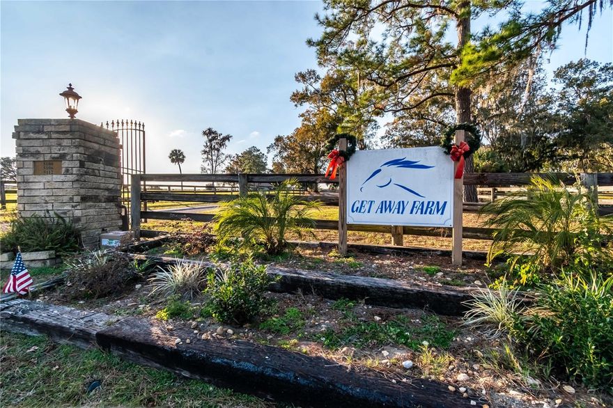 Equal parts elegant homestead and serious equestrian operation, this 50+/- acre farm offers the rare combination of refined living and top-tier horse facilities in the heart of Ocala's premier equestrian region. Just a short drive from both HITS and the World Equestrian Center (WEC) and minutes from Ocala and I-75, the location alone sets this property apart. Fenced and gated with a paved driveway, the property features rolling green pastures and paddocks stretch out in every direction, each thoughtfully designed to include their own mature oak trees for much needed shade. Two high-quality barns offer a combined 32 stalls, including a smaller 7-stall barn ideal for stallions or foaling. A eurocizer, round pen, and ample open space round out a training environment designed with serious equestrian operations in mind from start to finish. One well and two septics provide exceptional water access and operational capacity. The residence includes a warm, welcoming A-frame main home with vaulted ceilings, a stone fireplace, and sunlit gathering spaces. The open kitchen flows easily into the living and dining areas, while the primary suite on the main floor provides privacy and retreat. A separate office building supports business operations, and could easily be converted for use to an additional residence or continued to be used for business. For the buyer seeking a true equestrian estate where impressive infrastructure and room to grow all come together, this is a one-of-a-kind offering in one of Florida's most celebrated horse communities. For those looking for higher acreage and additional residential options, barns, and more, OM722441 offers an additional 50+/- acres purchase directly next door.