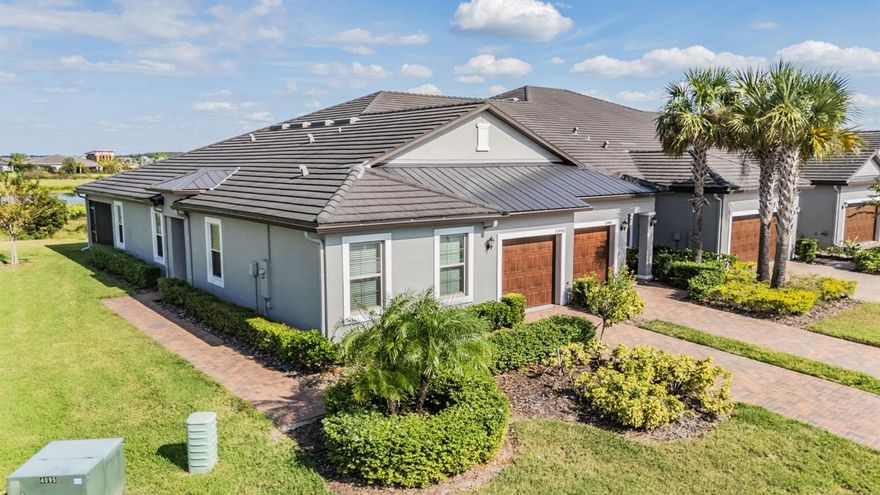 Medley Active Adult for those better than 55 years young presents an exceptional lifestyle just beyond the confines of your home. As a resident, you'll enjoy exclusive Clubhouse access with a full calendar of events daily! You will also enjoy a grill & bar, heated pool w/cabanas, ballroom, billiards room, card room, state of the art fitness center, pickleball & tennis courts, bocce ball, yoga, line dancing and private active adult events. PLUS included in your HOA is a 15-acre lagoon membership w/soft, sandy beaches including a swim-up bar, kayaking, paddleboarding, obstacle course, waterslides, corn hole games, and tons of community events! Be sure & invite friends or family to come along with you as you may gift them passes or pay a deeply discounted rate! This immaculate villa will please even the most selective buyers! Comprised of 2 spacious bedrooms, 2 full bathroms, a den/man cave and 1 car garage. Your new home includes lots of upgrades including wood look tile flooring throughout (no carpet anywhere!) agreeable gray walls with rounded corners, crown molding, quartz countertops throughout, upgraded lighting, stainless appliances and upgraded cabinetry. Sliding glass doors lead to your tiled and screened in lania with pond and conservation view. Great way to enjoy the beautiful weather without all the critters! As you step inside, you'll be greeted by a seamless flow of open living spaces, making it ideal for both relaxation and entertaining. Get ready to make memories that will last a lifetime! Your dream home awaits, you will be enjoying the CAREFREE FLORIDA RESORT LIFESTYLE in your new home as quickly as you are able to move in! Gorgeous curb appeal on this block villa with PLENTY OF ADDITIONAL PARKING just steps away from your villa for your convenience. Enjoy 42" Cabinets, and Walk-in Pantry with custom built-ins in this gorgeous kitchen. Primary Suite includes ensuite bath, dual sinks, grab bars, water closet and walk-in Closet with custom built-ins to keep you organized, and ceiling fans to keep you cool. Seller has also added rain gutters and pull-down stairs in the attic with additional floored storage space which are included in this energy efficient home. High-speed (ULTRAFI) internet, premium cable, yard maintenance & exterior painting as well as roof and homeowners insurance for the structure are maintained by the HOA. The location of this residence is equally remarkable with plenty of extra parking spots for your guests and situated in close proximity to premier shopping destinations, and an array of dining options, you'll find yourself immersed in a vibrant community that strikes a perfect balance between exclusivity and convenience. Ride your Golf Cart to the Clubhouse, Publix, restaurants, Farmers Market and more right inside the neighborhood! Close to Advent Health Hospitals, BayCare Hospital, Florida Medical Clinic, Wire Grass Mall, Tampa Premium Outlet Mall, Krate at the Grove, Sam's Club, Costco, Golf Courses & Movie Theater. Easy access to I75, 275, Tampa International Airport, Downtown Tampa and Florida's amazing beaches. CDD IS ALREADY INCLUDED IN TAX AMOUNT.