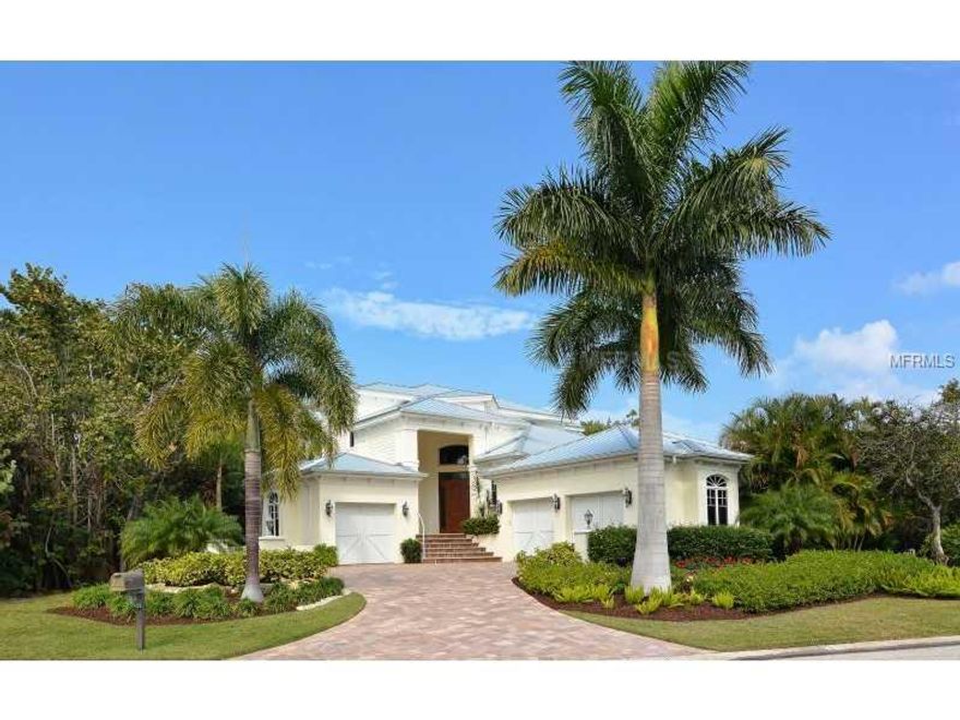 You can’t beat the value of this newly-built coastal inspired residence with 171 feet of protected waterfront on secluded Longboat Key.  This 4BD+Den/4.5BA home was built in 2010 and is fully hurricane compliant with impact windows/doors, stainless steel roof, split 3-car garage & terraces for outdoor living.  The living room showcases a 22-foot ceiling, walls of glass, soft up-lighting, beautiful hardwood floors, coral stone gas fireplace, wet bar with wine refrigerator and views of the tropical lagoon, designed for entertaining and time with family & friends.  Privacy & solitude abound in this waterfront retreat in a true wildlife haven, where you can see manatee & birds from your private dock/boat lift with no bridges & direct access to the bay.  The spacious cook’s kitchen boasts wood cabinetry, spanning granite countertops, stainless appliances, gas stove with grill, double oven with warming drawer, oversized island with prep sink & expansive bar seating.  The ground-floor owner's suite offers a 12-foot coffered ceiling, spacious sitting area, 2 walk-in closets and a large bath complete with spa tub, European dual-head walk-in shower with bench & dual sinks.  Plenty of storage & an elevator shaft for convenience.  A complete summer kitchen overlooks the heated pool and spa.  A rooftop sundeck offers incredible natural Florida views.  This community of seven owners has beach access & is only 20 minutes from cultural downtown Sarasota, St. Armand's Circle and IMG Academy.