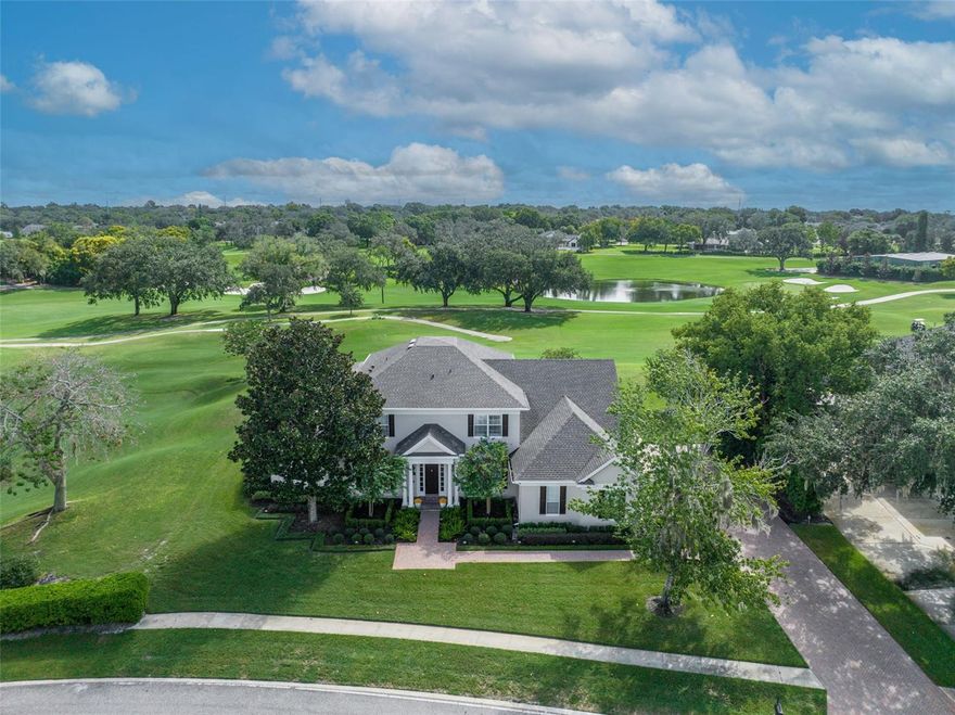 IMPROVED PRICE! Welcome to a TRULY EXCEPTIONAL CUSTOM HOME in the heart of the sought-after community of BAY HILL featuring Magnificent and Expansive Golf Course Views! Situated on an almost 1/2 acre lot overlooking the 8th Hole of the Champion Course at the Exclusive Arnold Palmer’s Bay Hill Club and Lodge, this Estate Home offers elegant touches and major upgrades throughout. Totally rebuilt in 2004, this Stunning HOME is truly a Showplace featuring 5 bedrooms and 4.5 baths with over 5500 square feet of thoughtfully laid out living space. As you step inside, you will immediately notice the attention to detail with the gorgeous wood floors and custom millwork. The chef-inspired kitchen boasts tons of Custom cabinets, a walk-in pantry, a wood block prep island, a convenient breakfast bar, and of course all top-of-the-line SS appliances to make entertaining and meal prep a dream. Overlooking this exceptional kitchen is the spacious family room family offering a classic beverage bar and custom bookshelves all overlooking the stunning backyard and pool area that features a SALT Water Pool, an expansive deck and patio, and even an outdoor shower, which will certainly be the perfect place to relax and unwind with Family and Friends. Amazingly, there are captivating views from almost every window of this remarkable home that is flooded with natural light and ambiance. Also, tucked away on the first floor is the elegant primary suite featuring a NEW spa-inspired bath that offers double sinks, Custom cabinetry and tile, a large walk-in shower, a luxurious soak tub, and a Water Closet. This exquisite owner’s retreat also enjoys a quiet sitting area, a private patio, and an expansive new custom walk-in closet that will truly impress. Rounding out the first floor is a comfortable and quiet study with custom bookshelves, a guest suite, a laundry room with tons of storage cabinets and even a laundry chute, a convenient mud room, and of course, an elegant dining and living room to entertain in style. Upstairs are 3 well-appointed bedrooms, 2 full baths, and a large play and game room all surrounded by an enormous media loft that offers a great space to gather the FAMILY on Movie night or Football Sunday with a wet bar that opens up to a truly fantastic rear Balcony with plenty of space to entertain and take in the Magnificant jaw-dropping VIEWS of the Championship Golf Course! Other amenities include a large 3-car garage, tons of closet space, all NEW lighting, plantation shutters, and a freshly painted Exterior! Enjoy Florida living at its finest with HOA member privileges to the Butler Chain of Lakes Marina and Boat Ramp, 24-hour Security, and access to a playground and a dog park. An OPTIONAL Membership to the Bay Hill Club and Lodge features many amenities including the 27 Hole Champion Course, Fitness Center, Tennis Courts, Pool, and Fine Dining. This extraordinary home effortlessly blends timeless LUXURY, breathtaking views, and an excellent location near Orlando’s well-acclaimed restaurant row, shopping, dining, and Orlando’s famed attractions. Zoned for some of the best public schools in the area. Just a short drive to Orlando International Airport and to Orlando’s bustling downtown, make this a prime location. Don't miss your chance to own this exquisite piece of BAY HILL PARADISE.