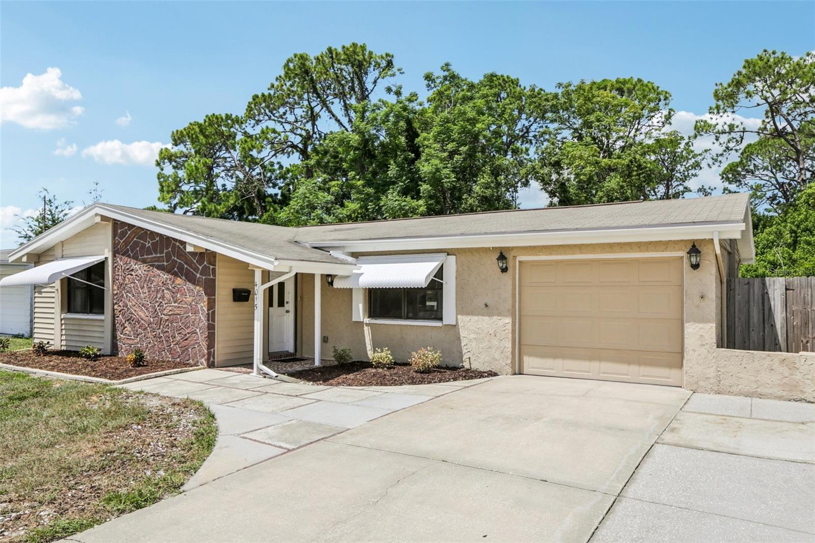 Discover serene living in this 2-bedroom, 2-bathroom home with no rear neighbors and tranquil views of a protected nature preserve. Featuring an oversized parking driveway for multiple vehicles, this property offers convenience and flexibility. Inside, you’ll love the luxury vinyl flooring throughout, creating a modern, low-maintenance finish that complements the open-concept living space. A bright Florida room provides the perfect spot to relax and take in the peaceful surroundings year-round. Ideally located close to major amenities, stunning Gulf beaches, and historic Tarpon Springs, this home blends quiet privacy with easy access to shopping, dining, and entertainment. Perfect as a primary residence, vacation getaway, or fantastic investment property.