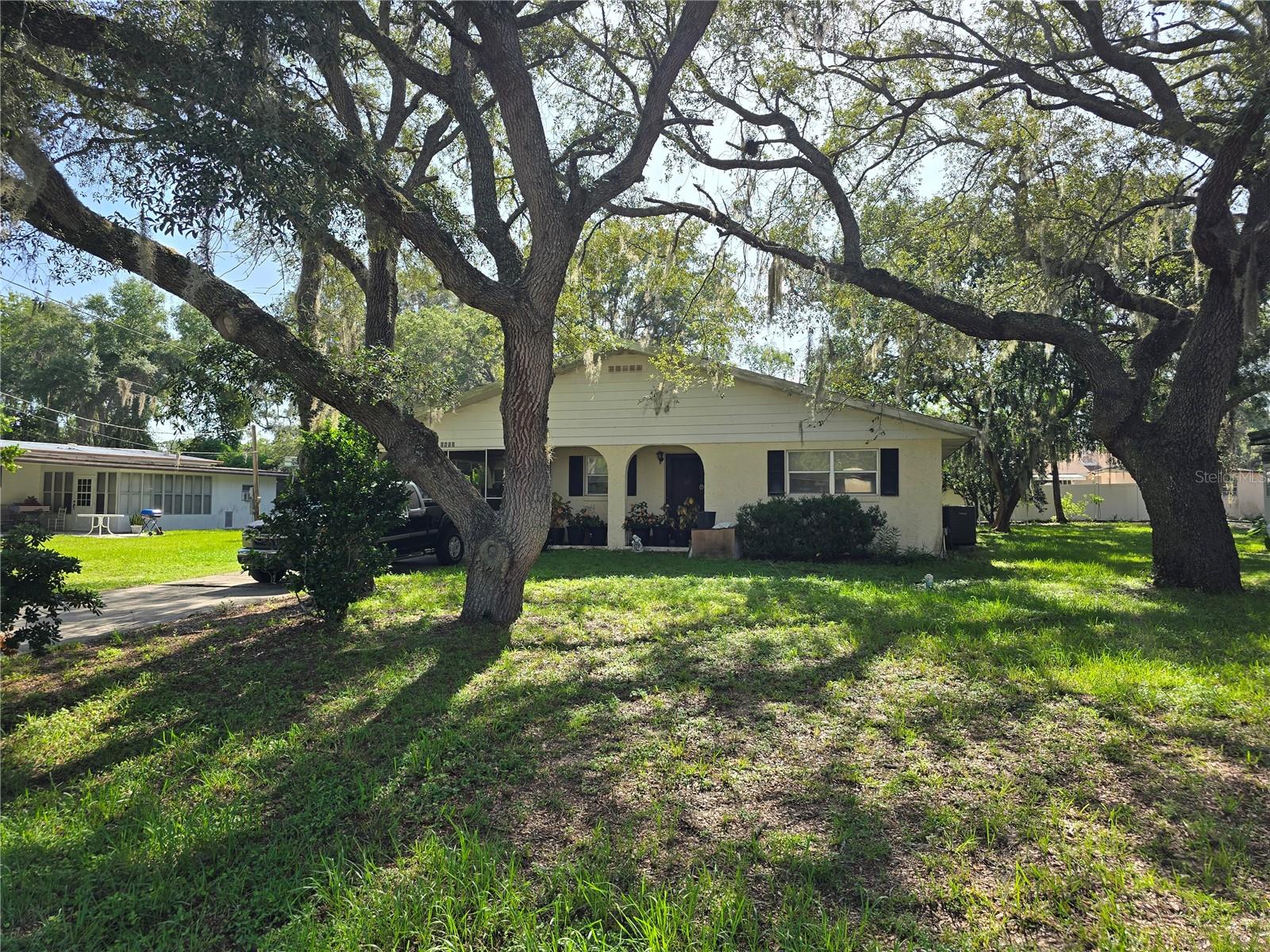 This home features 3 bedrooms, 2 baths and 1572 square feet of living space under air. It has an additional workshop room and laundry room for additional square footage and storage not under air located just behind the screened in carport. When you enter through the front or side doors you walk into the kitchen, dining and living areas that are located in the front of the home. The two larger bedrooms are located at the back of the home. You can access the additional living space and laundry through the primary bedroom or the screened carport.
Silver Springs Woods subdivision adjoins Ocala National Forest and only two miles from amenities including grocery store, post office, bank, CVS and restaurants. The beautiful Silver Springs State Park is located 15 minutes west offering kayaking, paddleboarding, boating and nature walks. To the East are Juniper Springs and Astor which features fishing, hunting and boating on the St John's River flowing into Lake George.
Home needs some TLC but you can customize this home to your preferences. Being sold below recent appraised value.