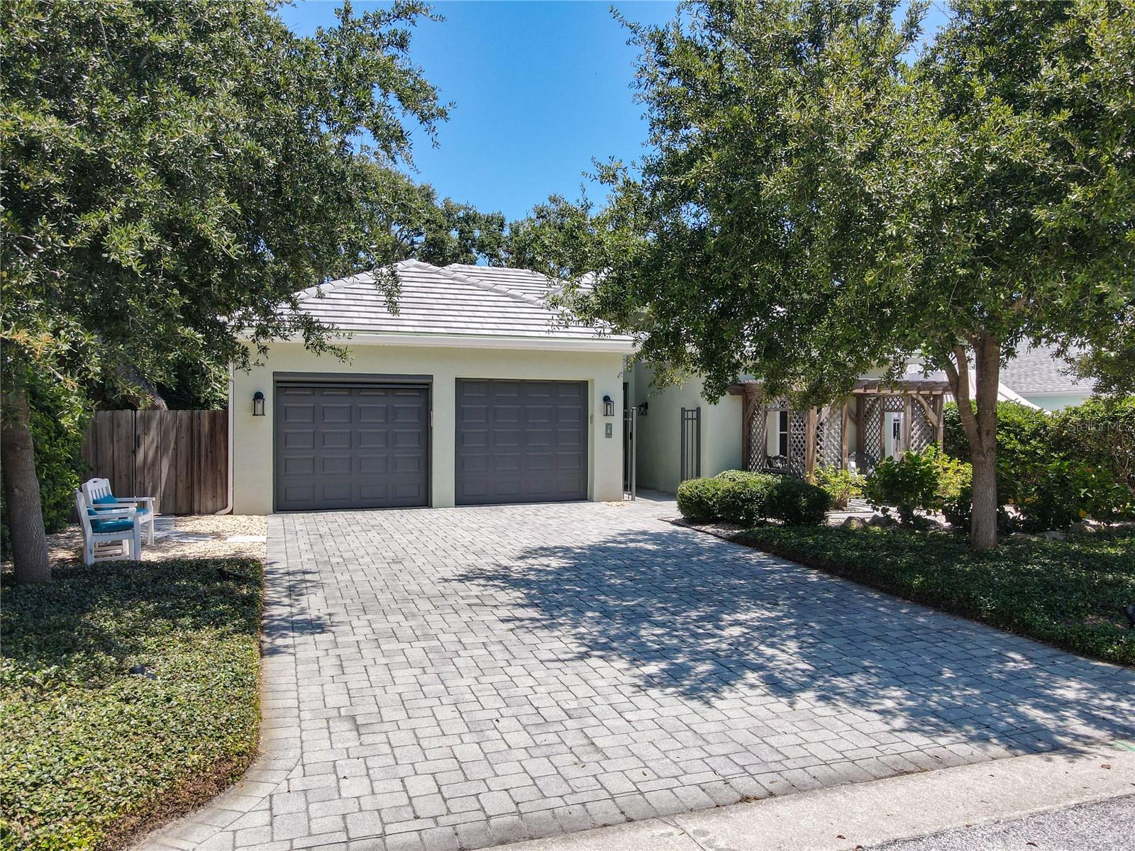 Discover an exquisite 3-bedroom, 2-bath pool home in the highly sought-after Lighthouse Shores area of Ponce Inlet. This custom-built Robert Edwards residence offers an open floor plan, showcasing a serene screened-in pool with lush, private tropical landscaping. The modern kitchen boasts new appliances, contemporary cabinetry, a large breakfast bar, and overlooks the airy living room with an electric fireplace. Tile flooring throughout ensures low maintenance. The primary suite features a walk-in closet and a spacious, beautifully grand shower. A formal dining room, located off the kitchen, provides pool views through a sliding glass door leading to the covered porch. The new salt-chlorinated pool, complete with a travertine tile deck, features a fully automated Pentair app system, LED lighting, and a heated spa/pool. The backyard is a private oasis with mature, easy-maintenance tropical landscaping. Additional features include a newly painted exterior, motorized living room/dining room shades, new hurricane windows, a new peel-and-stick tile roof, new HVAC, updated interior lighting, a 13kw generator with transfer switch including whole-house surge protector, a paver driveway, and landscape lighting. The oversized garage includes a privacy screen. This home's prime location on a quiet, no-thru-traffic street is just steps from the Glenview Avenue no-drive beach walkover. It's also remarkably close to the Ponce Inlet Lighthouse Park, Marine Science Center, multiple restaurants, and a nearby marina. Orlando attractions are just an hour away.