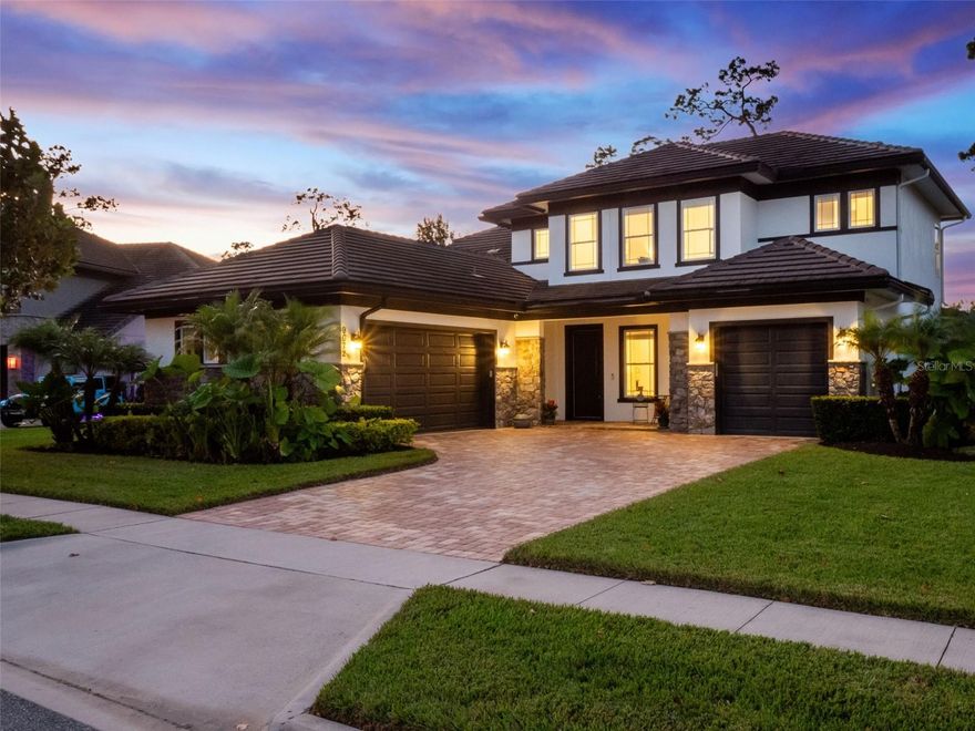 Experience the very best in true lakefront living where every detail has been carefully designed for comfort, style, and enjoyment. Located in the heart of Winter Garden within the highly desirable Latham Park community, this extraordinary residence combines modern luxury with the serenity of waterfront living. Perfectly positioned less than two miles from Walt Disney World and a short stroll to new shops and restaurants, the home captures the essence of convenience and exclusivity.

Set on a beautifully landscaped 1.25-acre lot, this five-bedroom, four-and-a-half-bath home with a three-car garage offers sweeping lake views and private access to Lake Lartigue, a tranquil 42-acre freshwater lake ideal for boating, fishing, and watersports. The property’s private dock and outdoor living spaces make it perfect place to entertain and live the Florida lifestyle to the fullest extent.

Inside, refined design and craftsmanship are evident throughout. The first floor showcases an open-concept layout centered around a stunning gourmet kitchen featuring stacked cabinetry, quartz countertops, and a waterfall island that seamlessly connects to the spacious family room. Fully vented NATYURAL GAS cooktop and the pot filler faucet is always a postive.The formal dining room provides a sophisticated setting for entertaining, while large windows and glass doors fill the home with natural light and offer beautiful views of the pool and lake beyond.

The primary suite is a private retreat with direct access to the covered lanai and the heated saltwater pool and spa. Its spa-inspired bath features a floor-to-ceiling glass shower enclosure, modern finishes, and a serene ambiance that creates the perfect place to unwind. A second bedroom on the main level provides flexibility for guests or an office.

Upstairs, three additional bedrooms offer generous space, including a Jack-and-Jill bath that connects two of the rooms. The expansive game room opens to a screened-in balcony, where you can take in breathtaking panoramic views of the lake. Elegant wood flooring flows through the main living areas, complemented by tile in all wet spaces and 8-foot doors throughout. The home also includes a premium Sonos surround sound system for an elevated audio experience.

With 3,750 square feet of living space, this Grafton floor plan delivers both sophistication and functionality. Residents of Latham Park enjoy access to a community clubhouse, resort-style pool, and scenic nature trails perfect for leisurely walks. The location is unbeatable—just minutes from major highways, world-class dining, the Hamlin retail district, and top-rated schools including Foundation Academy and Windermere Preparatory.

Tile roof, security system with google cameras, Culligan water filtration system, storage racks in the finished garages and seamless screen enclosure for perfect views are all worth stating.

From the moment you step through the door, you’ll know you’ve found something truly special—an impeccably maintained lakefront haven where luxury meets lifestyle in one of Central Florida’s most sought-after communities.